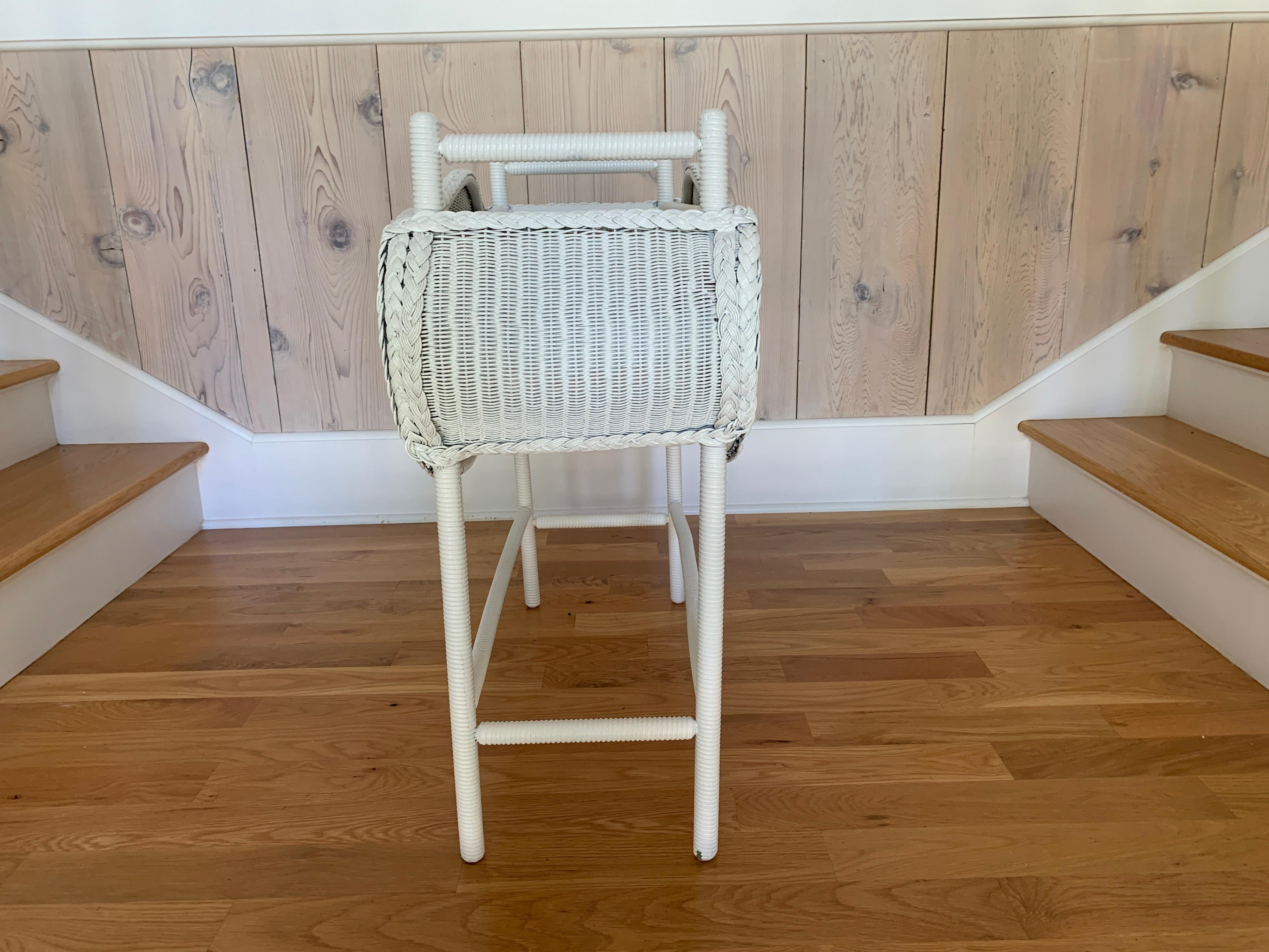 Vintage planter in the Lloyd Loom weave. Piece measures 31” wide, 28” tall, 12” deep. This piece should be used inside or outside under cover.