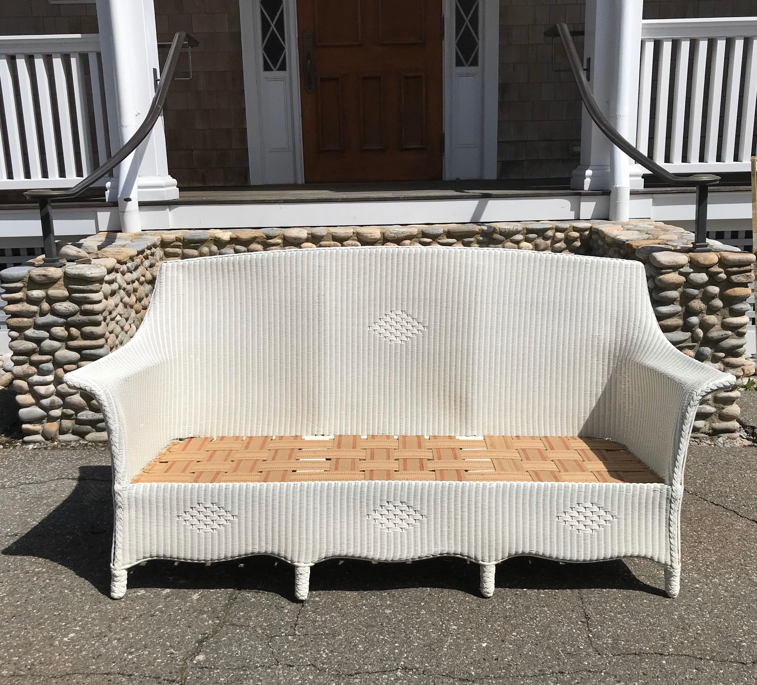 Antique Lloyd loom sofa. Clean and simple in style. Sturdy and comfortable. Sofa measures 70” wide, 26” deep, 36” tall, with a seat platform at 13.5”.