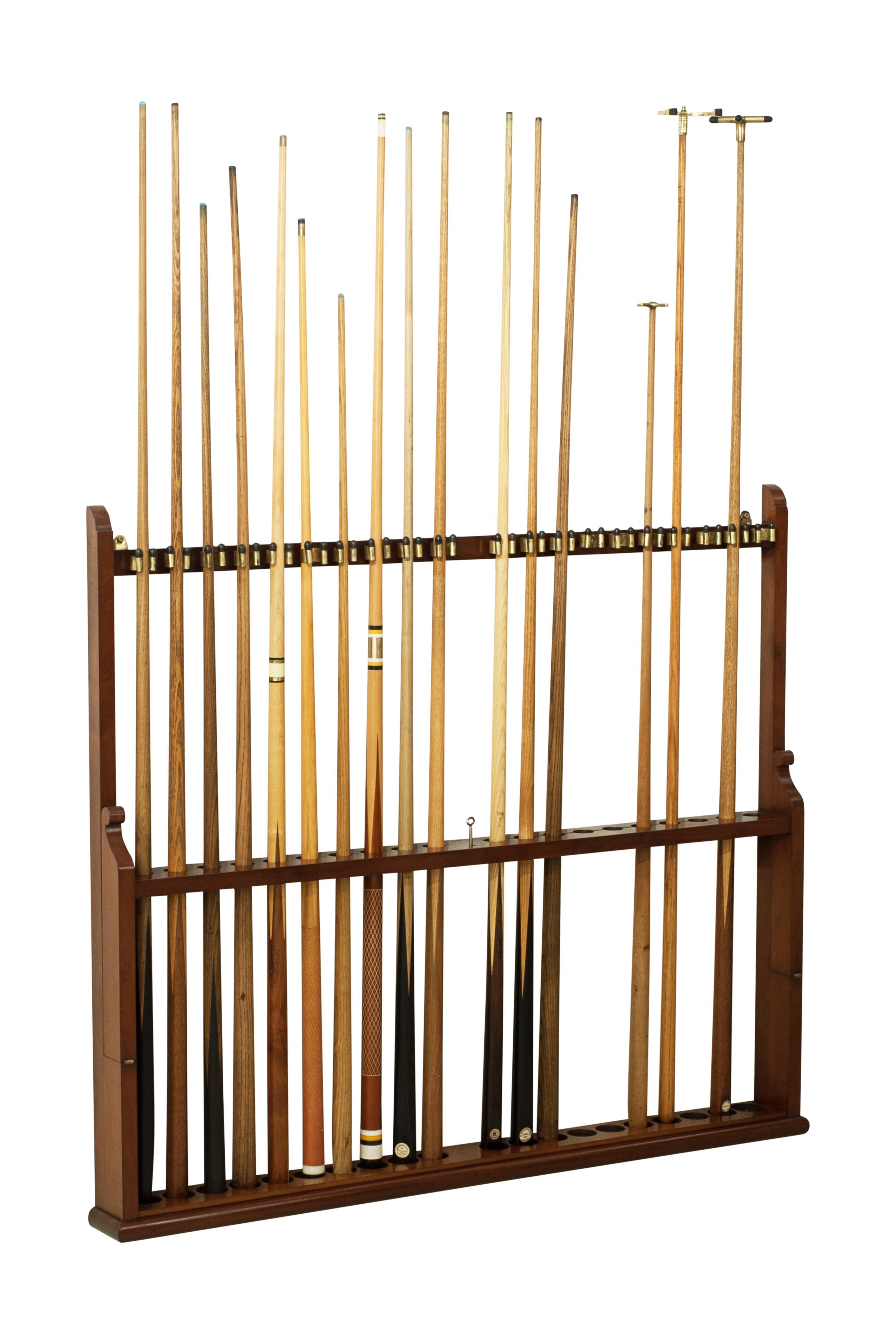 Wall-mounted cue rack.
A large wall-mounted lockable antique billiards, snooker, or pool cue rack constructed from mahogany. The rack will hold twenty cues and rest and clip in the brass clips at the top. There is then a hinged bar that lifts in
