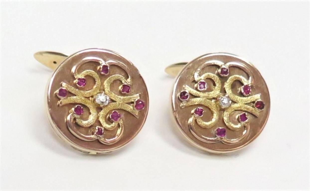 An extremely unusual pair of beautifully made 14 karat rose gold locket cufflinks, circa 1860. The front, and cover of each locket, has a swirl design and a center Old Mine Cut Diamond, approx. 0.05 Carat each, and eight antique glass rubies,