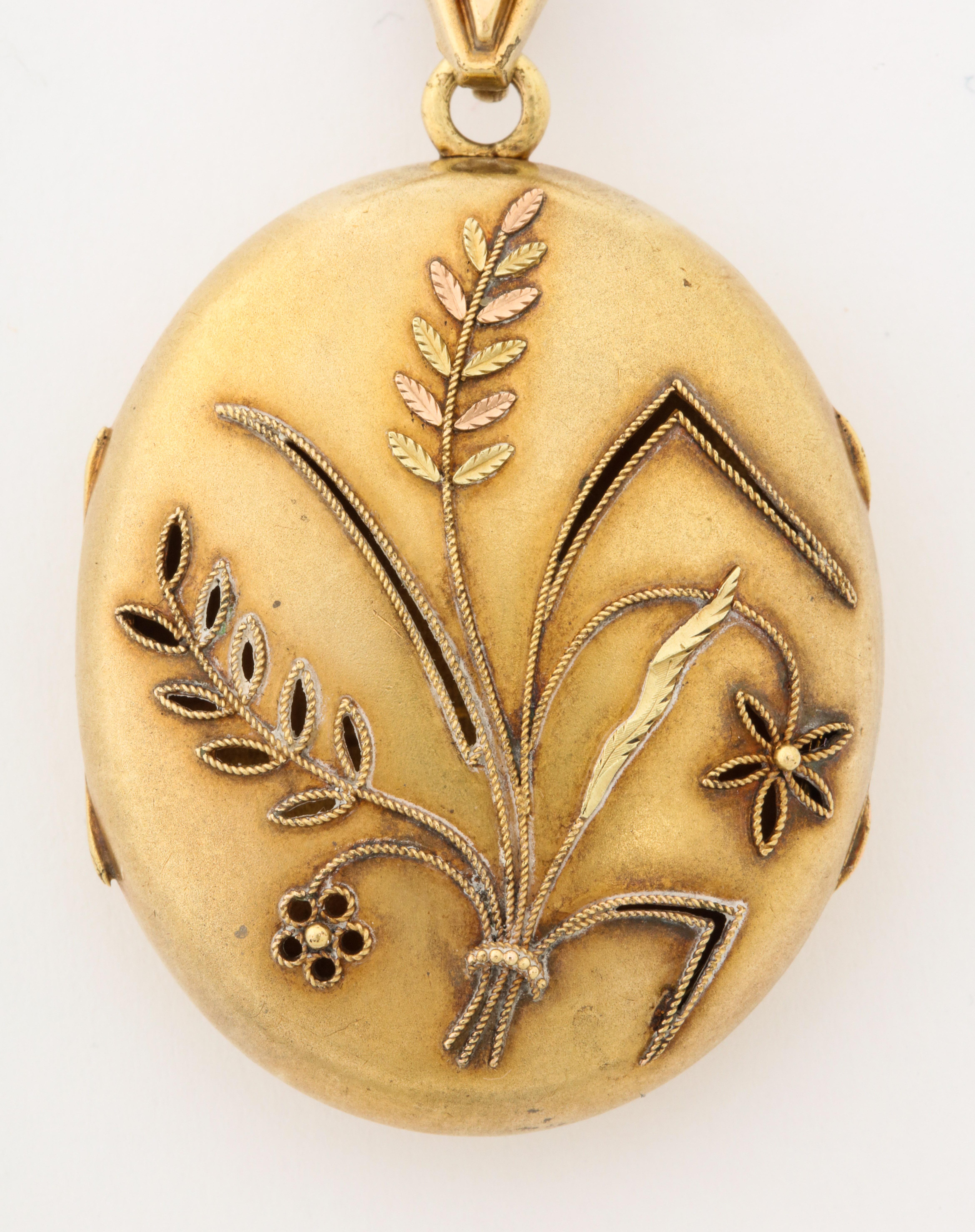 A lovely large oval 18K gold locket/vinaigrette with repousse sheaves of wheat. symbolizing fertility or productiveness. It has its original bale and is in very good 
condition.