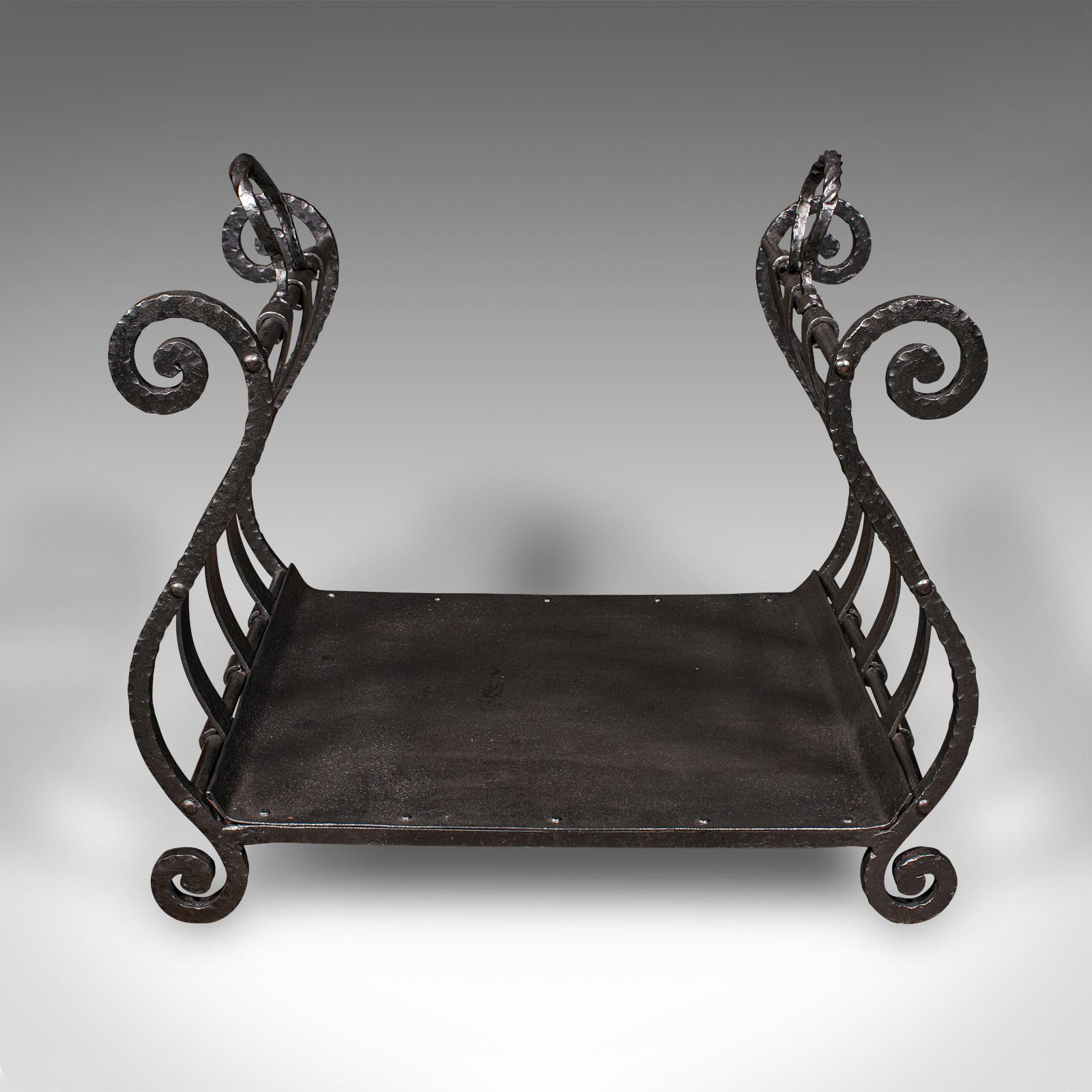 This is an antique log layer. An English, wrought iron country house fuel holder, dating to the early Victorian period, circa 1850. Of charming proportion and bold decorative appeal, ideal for traditional fireside settings.

Delightfully formed open