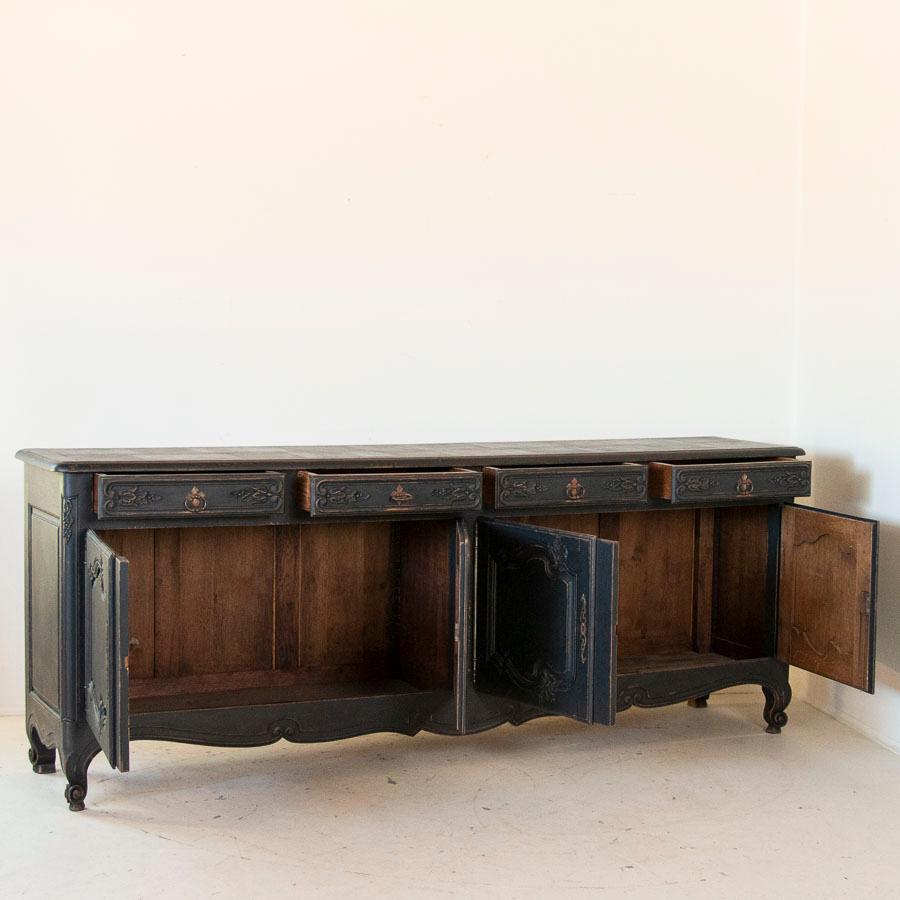 This elegant, long French sideboard or buffet is impressive in every way. Its length, at just over 8 ft. allows great opportunity for serving or display in a formal dining room. Notice the hand carved details in each panelled door and the feet as