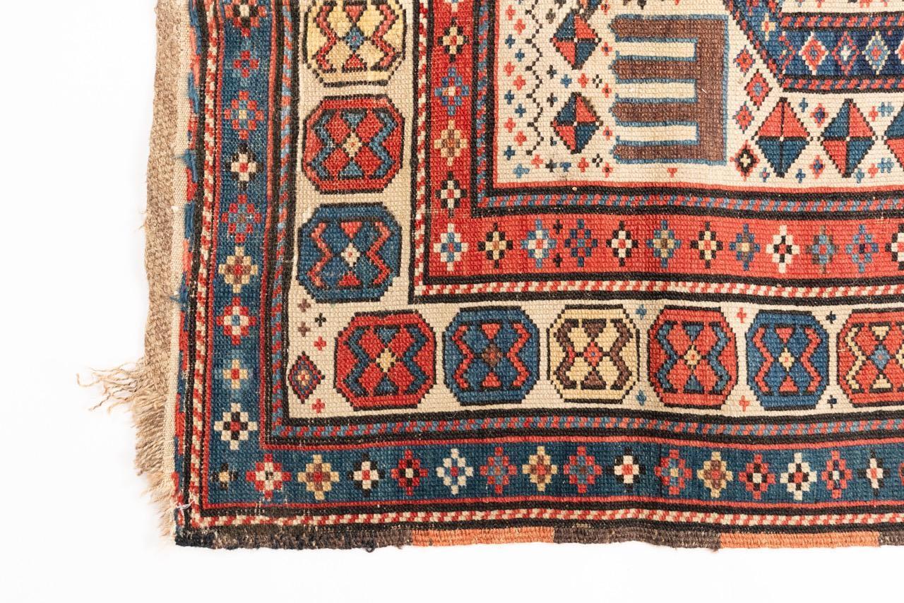 An unusually long prayer rug – and comparatively rare Gendje – in good condition. Above average centre field variation of colour and a particularly lively top Mihrab area to place in the direction of Mecca. The interior border with eight to ten