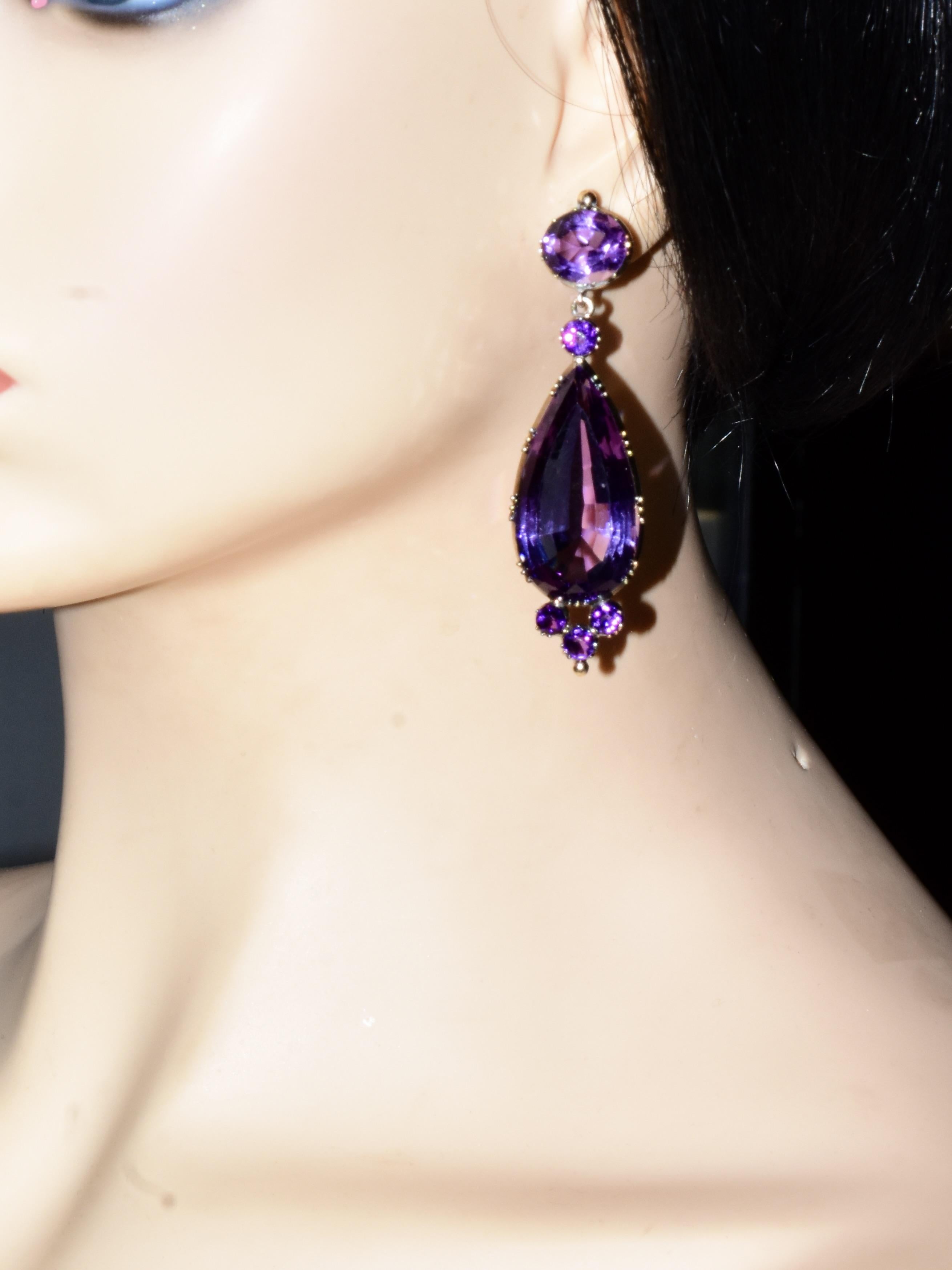 Long and dramatic 19th Century Amethyst Earrings.  The deep purple natural amethysts possess an estimated 68 cts of fine well matched amethysts.  The long pear cut stones weigh an estimated 28 cts. each.  These earrings are in fine condition, and
