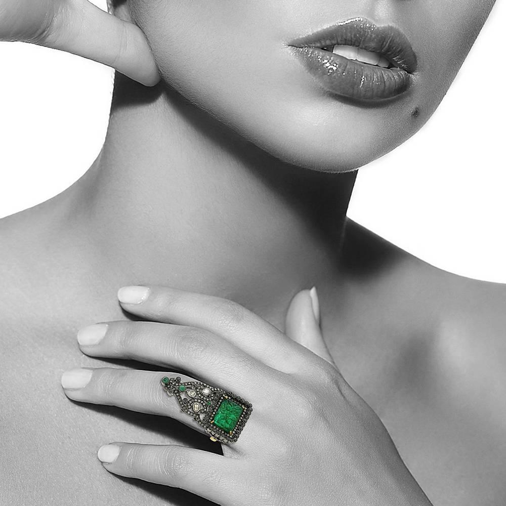Get the feeling of being royals with this Antique looking Carved emerald ring with black and white diamonds in silver and gold on shank. 

Ring Size: 7 ( can be sized )

18k:2.36g
Diamond: 2.42ct
Slv: 9.71gm
Emerald: 7.70ct