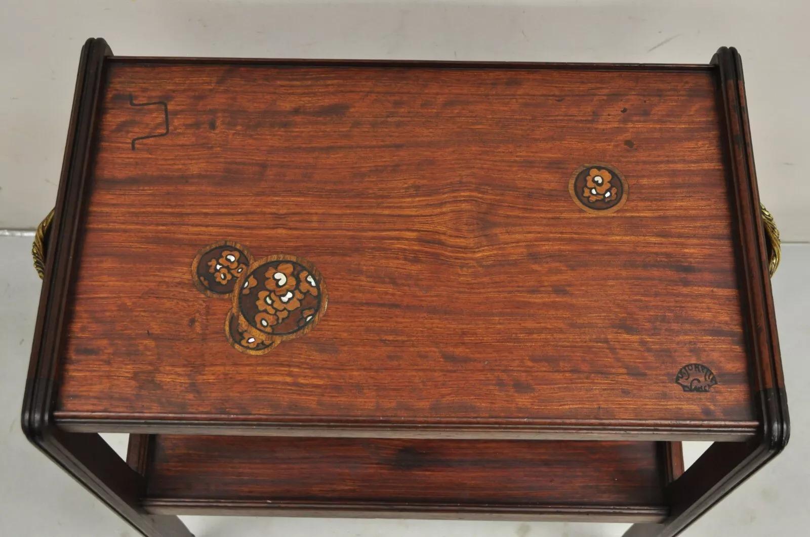 Antique Louis Majorelle French Art Nouveau Mother of Pearl Inlaid Mahogany 2 Tier Side Table. Item features shaped legs, ornate brass handles, beautiful wood grain, and original makers stamp. Circa Early 20th Century. Measurements: 30