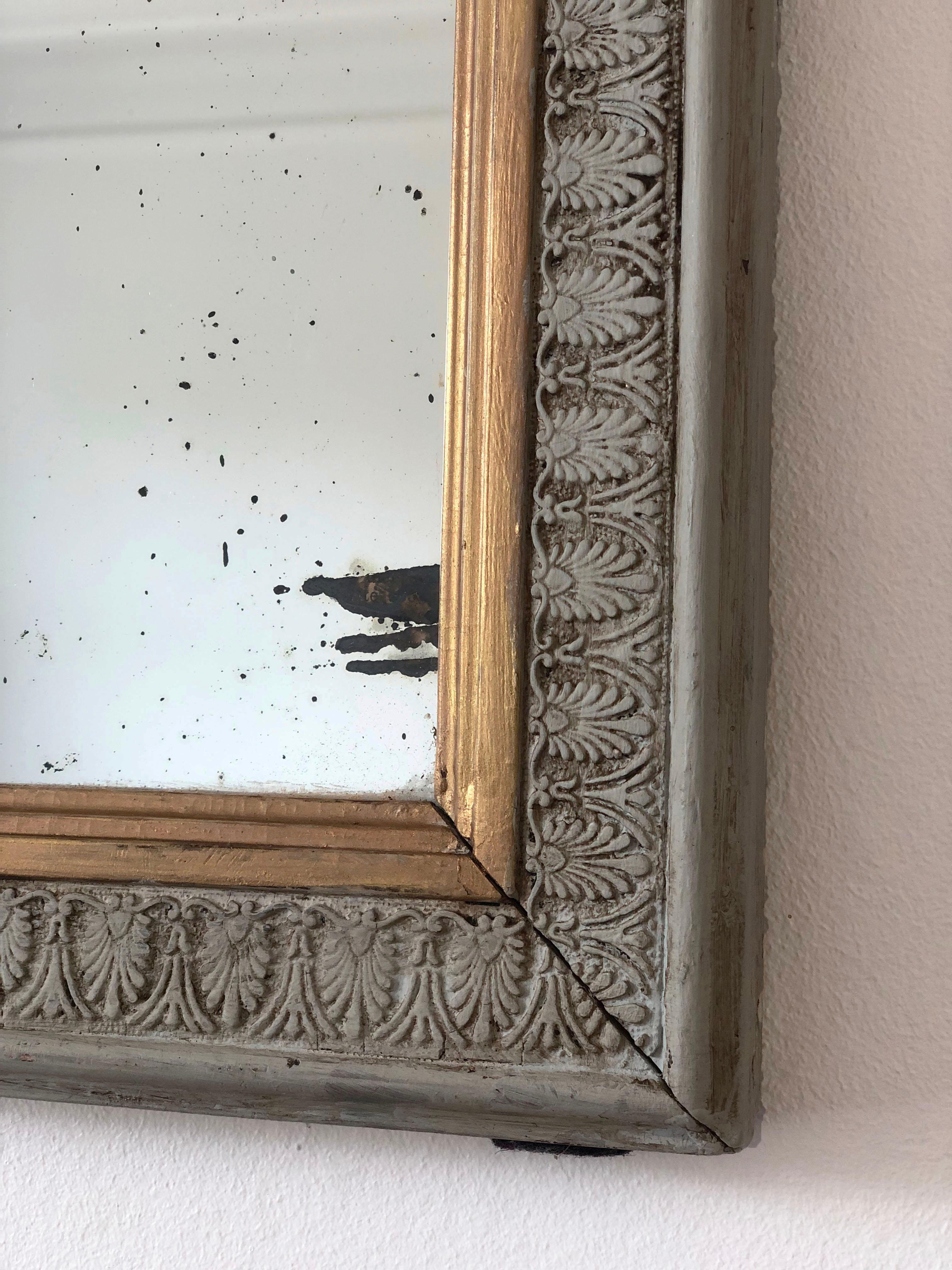 An enchanting antique Louis Philippe French mirror, dating to the late 19th century. The mirror features a refined carved white/green frame with a soft gold trim and a gracefully curved top, exuding timeless elegance and charm.

Object: