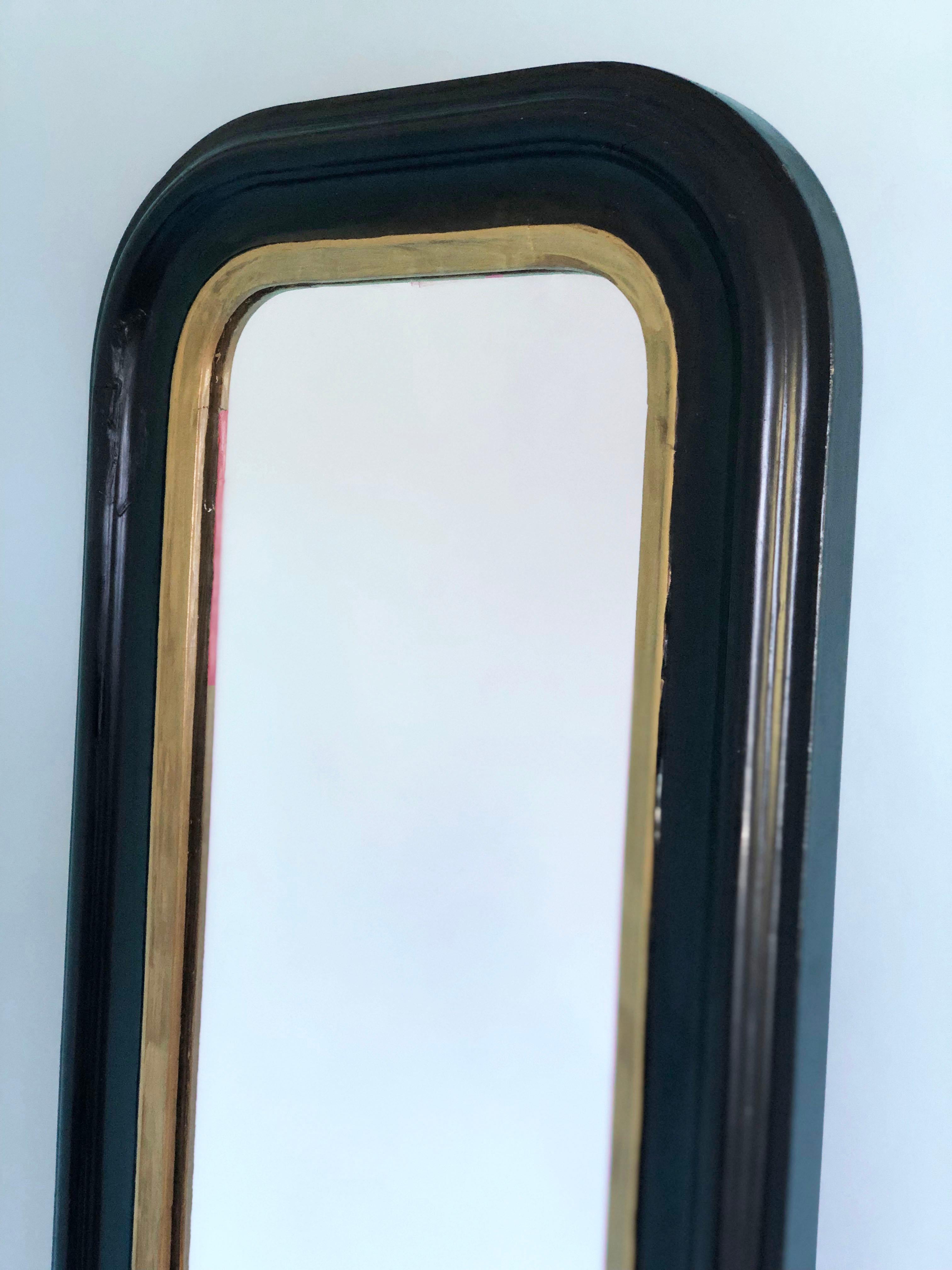 Antique 19th Century giltwood Louis Philippe Full Length mirror in black and gold with curved top corners. Original mercury glass and back.

Beautifully weathered mirror In good condition. France, Late 19th Century.

Object: Mirror
Designer: