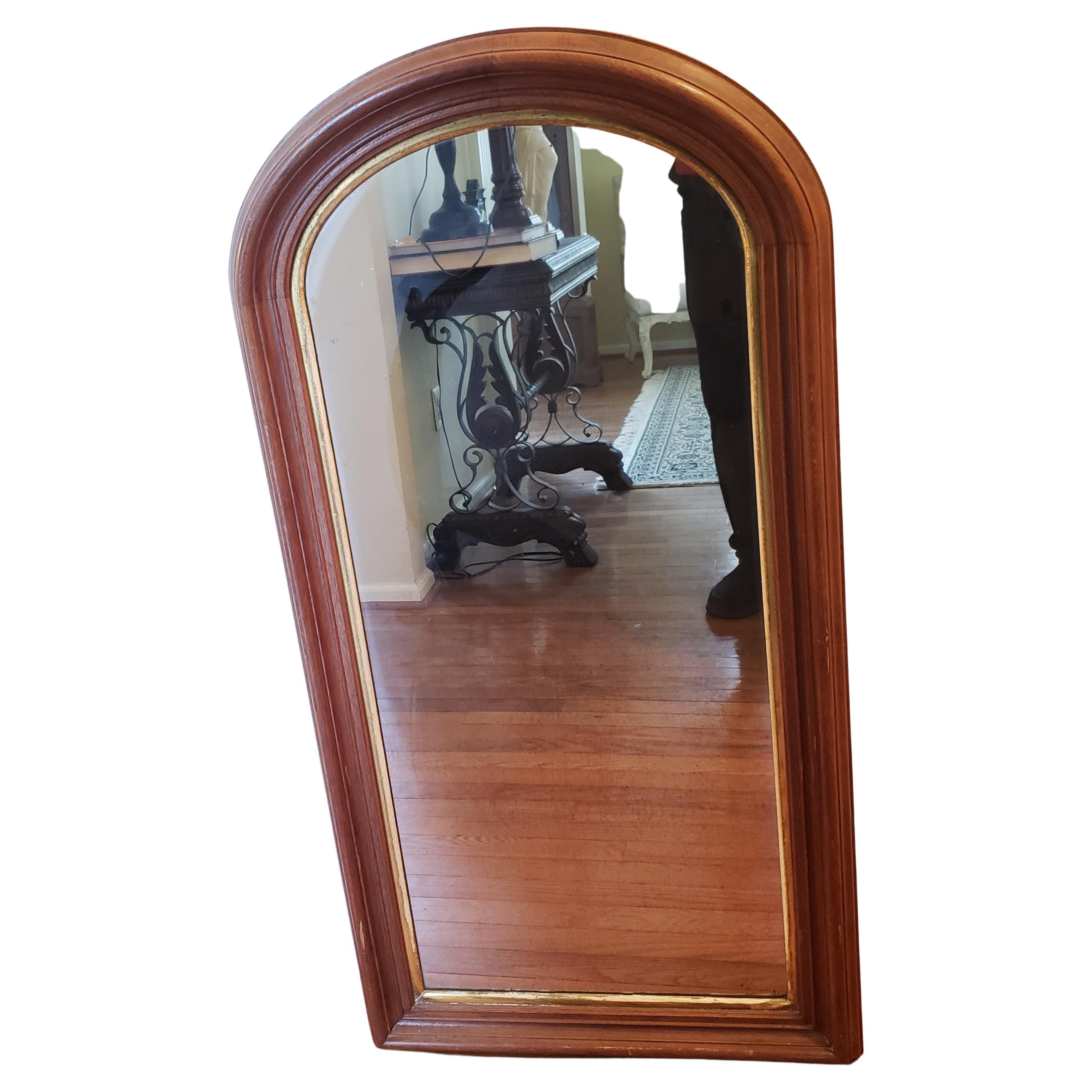 Gorgeous 19th century Louis Philippe wall mirror. Thick mahogany frame with interior giltwood trim. Mirror glass shows signs of wear and interior spots related to age. Hard Original back board protect the original mirror glass. Very good antique