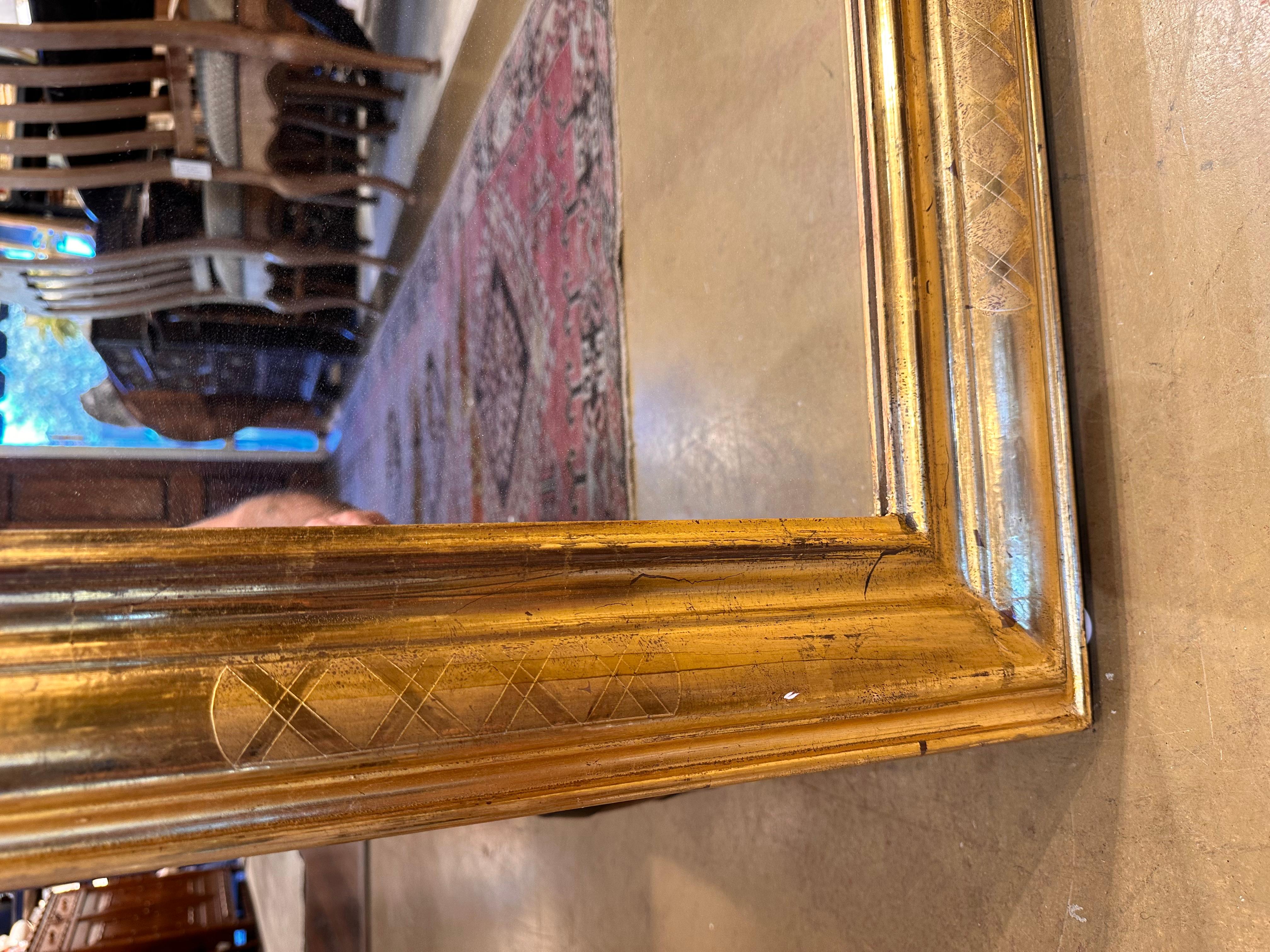 This is a beautiful Louis Philippe mirror! This mirror holds to a simple quiet design without a lot of busyness going on. However, there is delicate criss crossing on the edges that adds just a touch of ornamentation. This mirror is unique in that