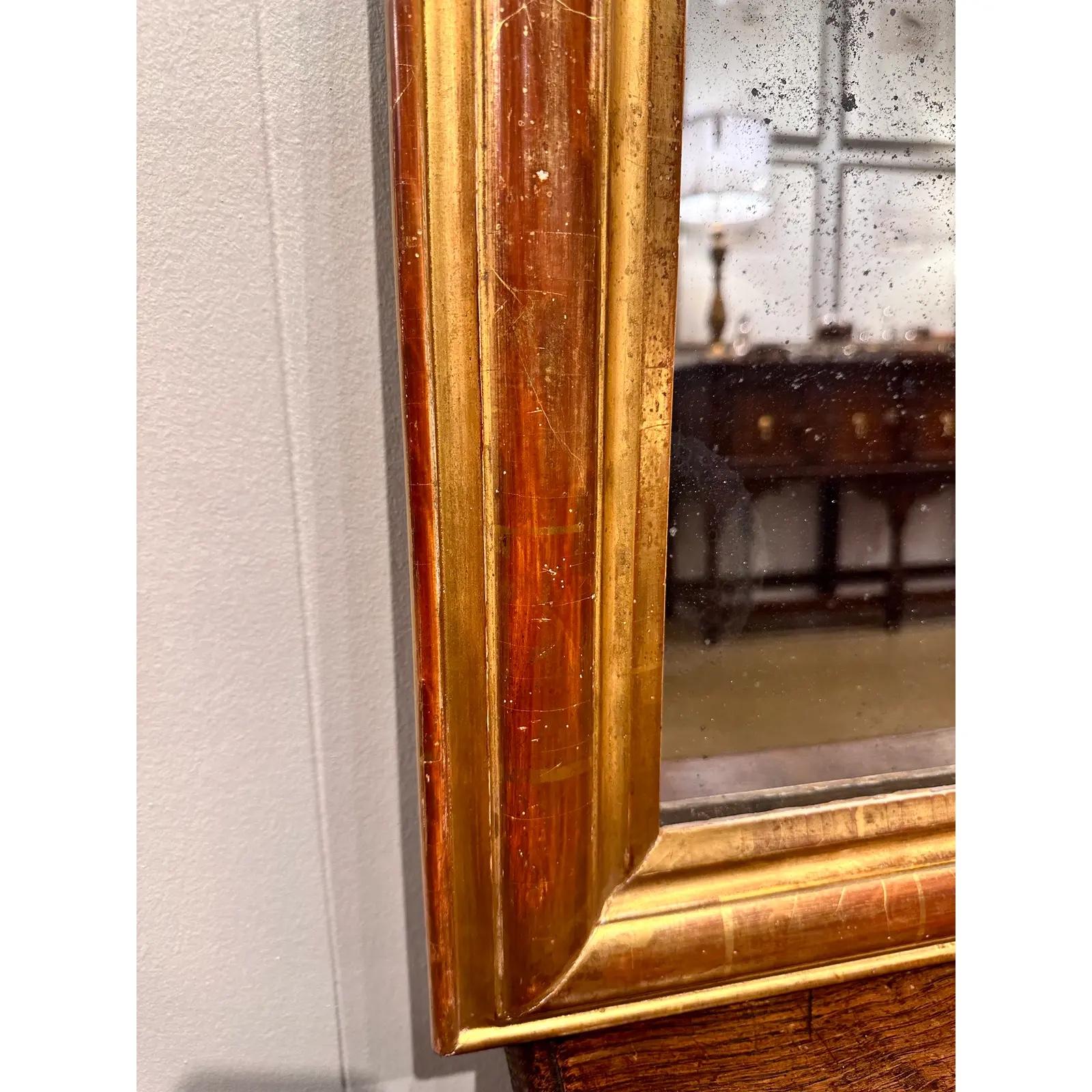 This is a beautiful Louis Philippe Mirror From the 1880s! This mirror is simple in style and yet still has plenty of character. It has also aged nicely with the gold has wearing off enough to show lovely patina and age. This mirror would work well