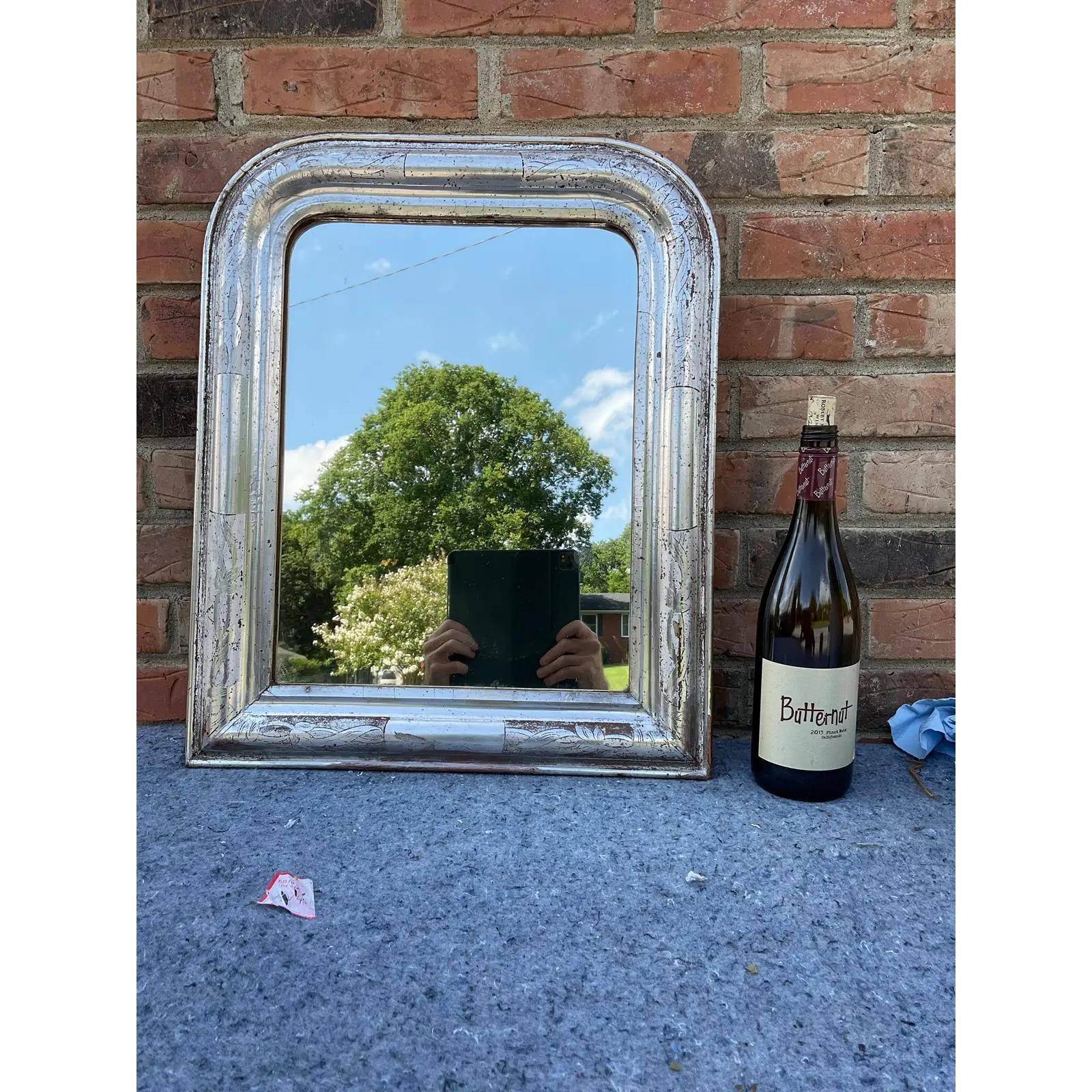 This 19th century Louis Philippe mirror is truly unique! Silver Louis Philippe style mirrors are not as common as gold, and this combined with this mirror's tiny size make this mirror an especially rare find. There is beautiful aging on this piece