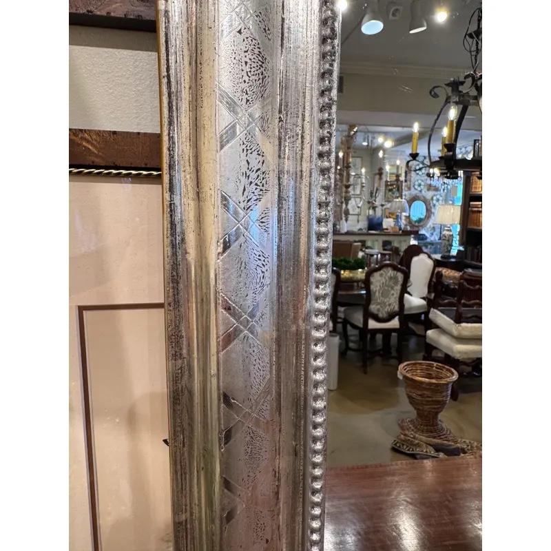 This is a gorgeous 19th century Louis Philippe Mirror! There is hand carved detail on the edges of the mirror in a simple but pretty style. Silver mirrors are harder to come by in this style making finds like this one special. This mirror has aged