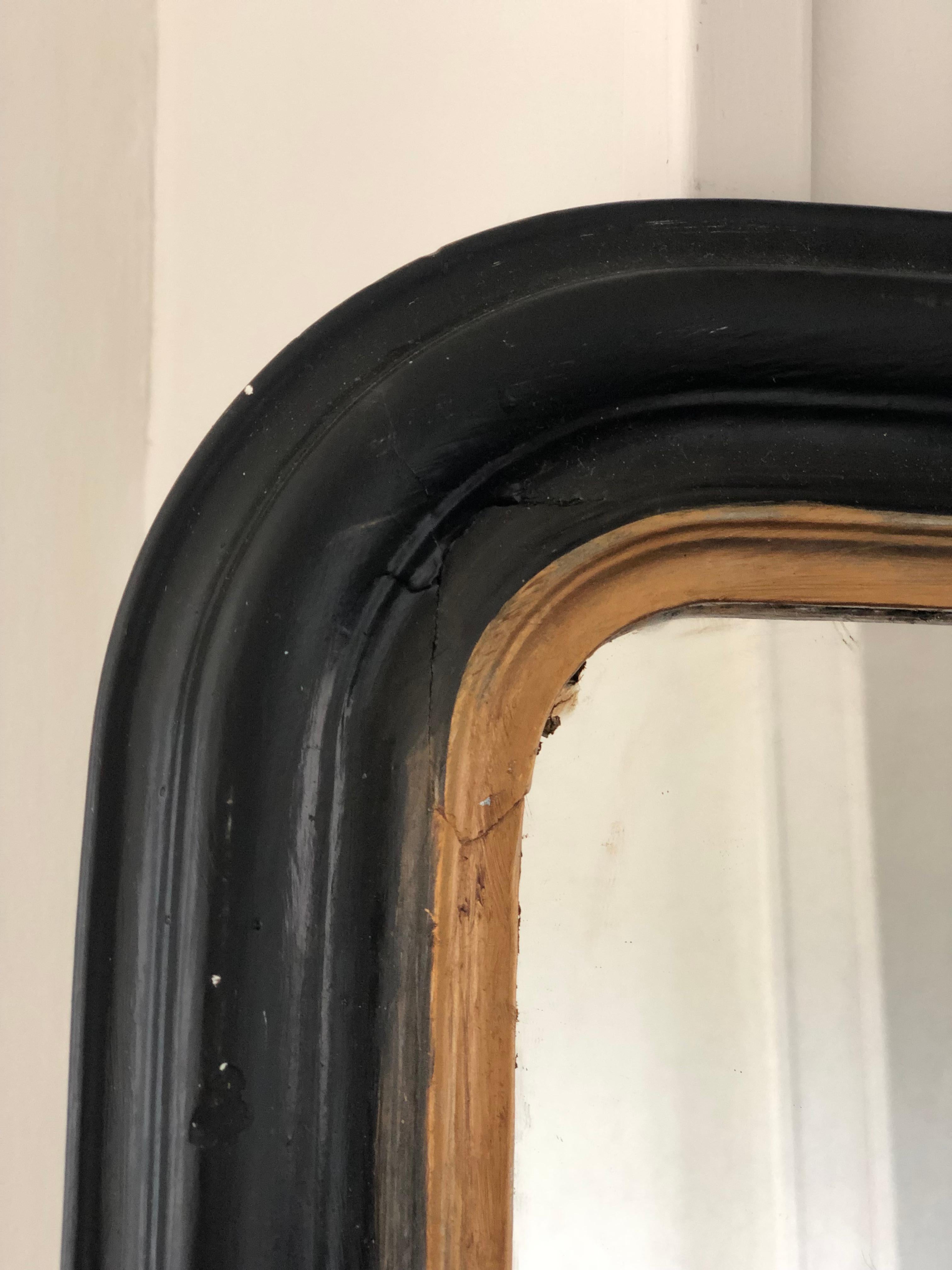 19th Century giltwood Louis Philippe mirror in black and gold with curved top corners. Original mercury glass and back.

Beautifully weathered mirror In good condition. France, Late 19th Century.

Object: Mirror
Designer: Unknown
Style: Antique,