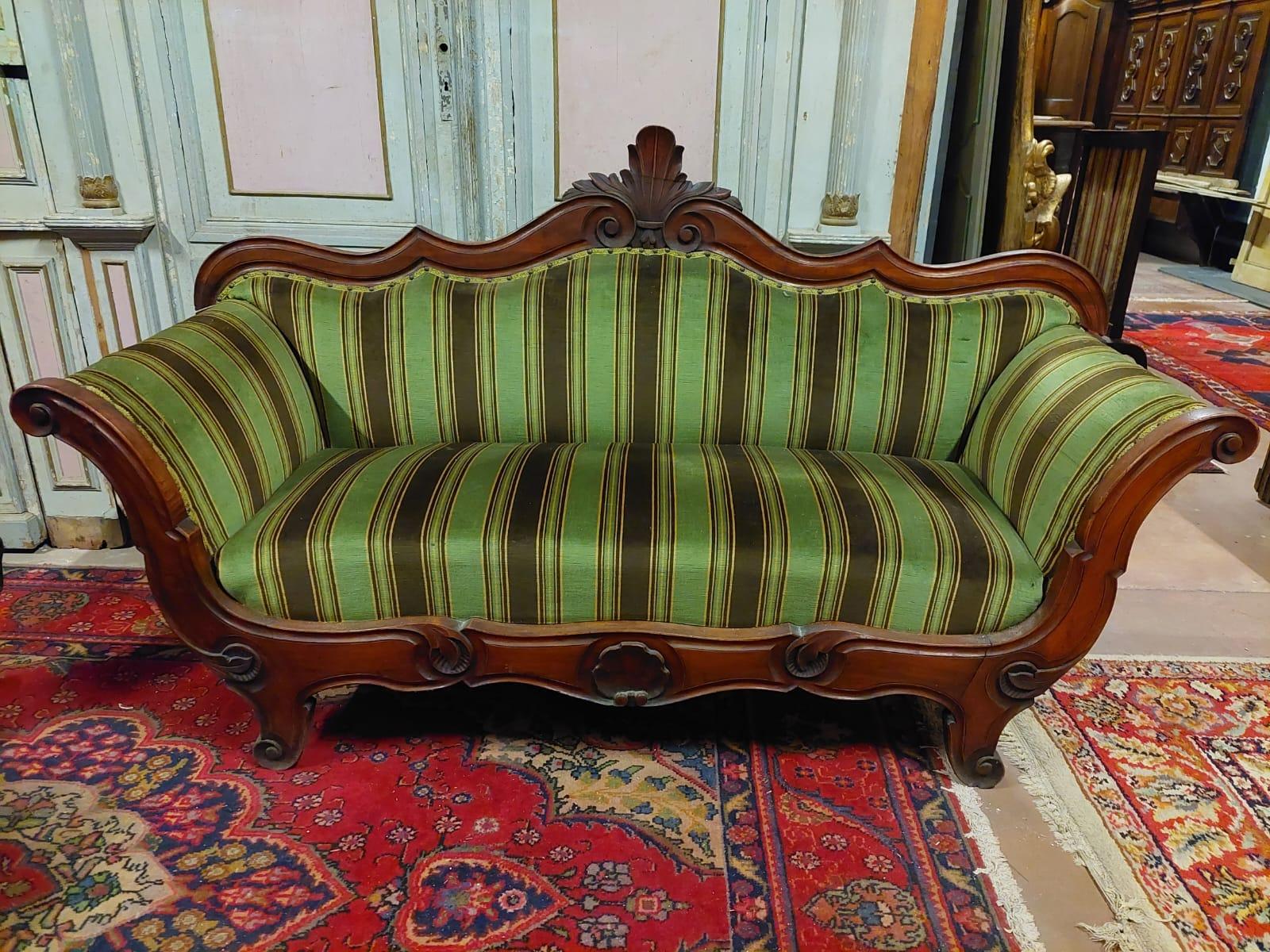 Antique and elegant Louis Philippe style sofa, hand-built in precious solid walnut wood inlaid with floral motifs and complete with green striped fabric, built in the 19th century in Italy.
Elegantly and finely carved and padded in the seat, back