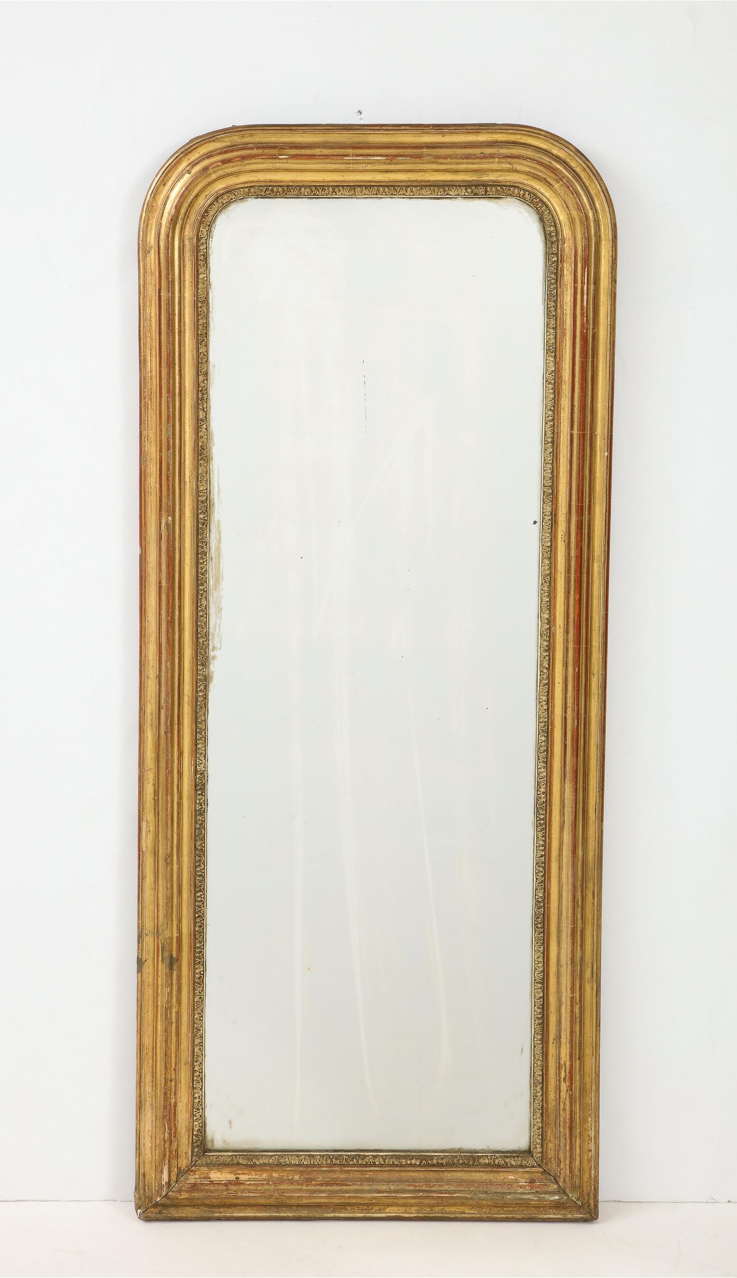 Brilliant Louis Philippe style wall mirror with gilt frame made in.... The frame has subtle acanthus leaf ornamentation and rounded upper corners that are typical of the Louis Philippe style. The mirror retains the original glass--which has a