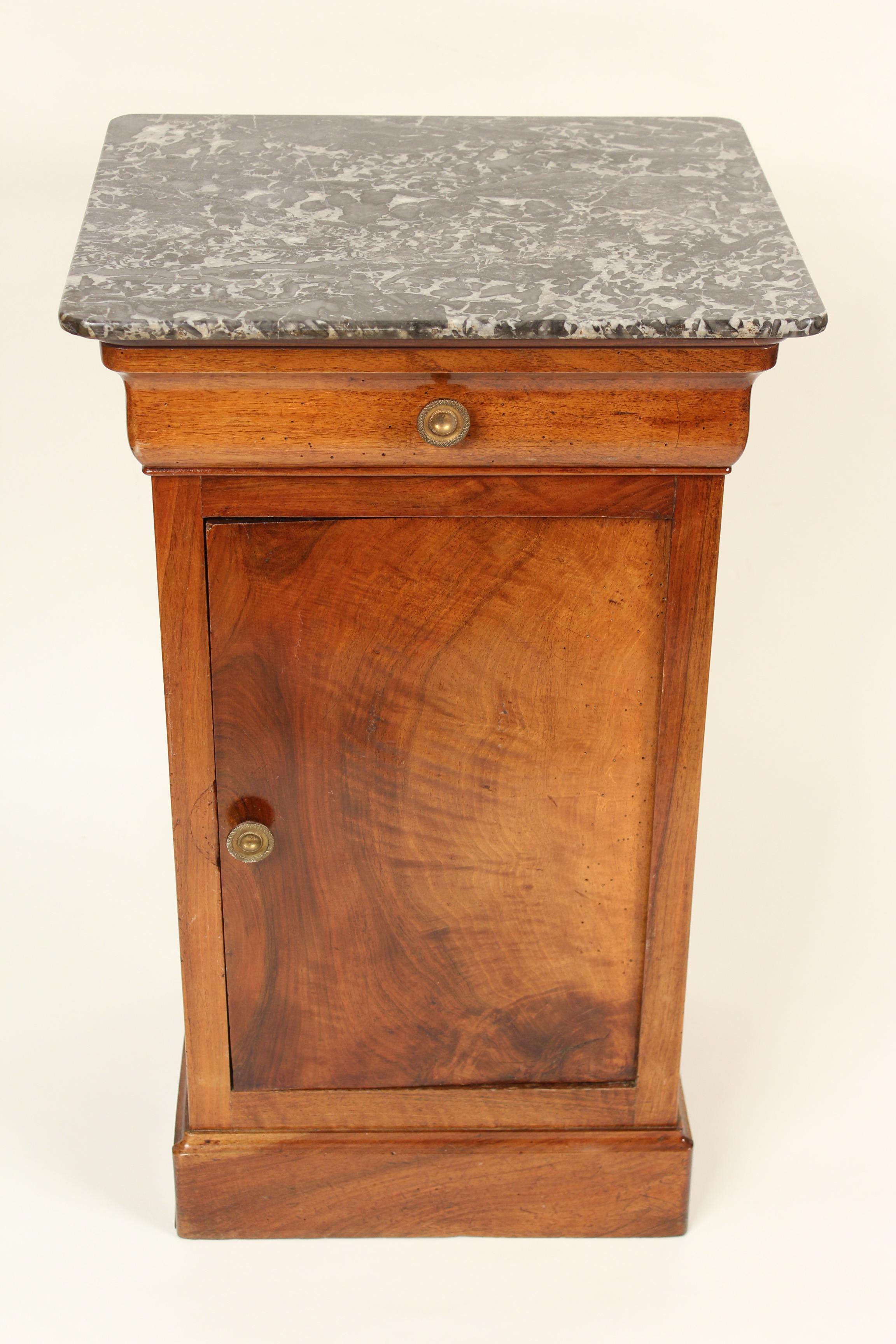 Antique Louis Philippe style walnut side table with original marble top, circa 1880. Notice the beautiful piece of walnut that was used for the door, both front and back are exquisite. Nice old original patina.