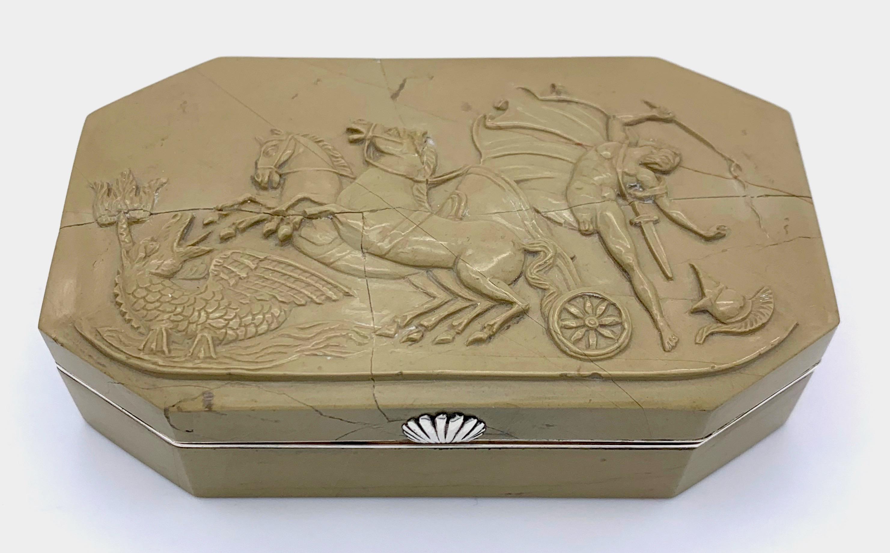 An antique warrior suffers the punishment of Poseidon, who sends a sea monster to frighten the two horses of the young man's chariot.  
Exquisite snuffbox with a fine soapstone carving mounted in a solid silver frame. 
The handsome snuffbox was