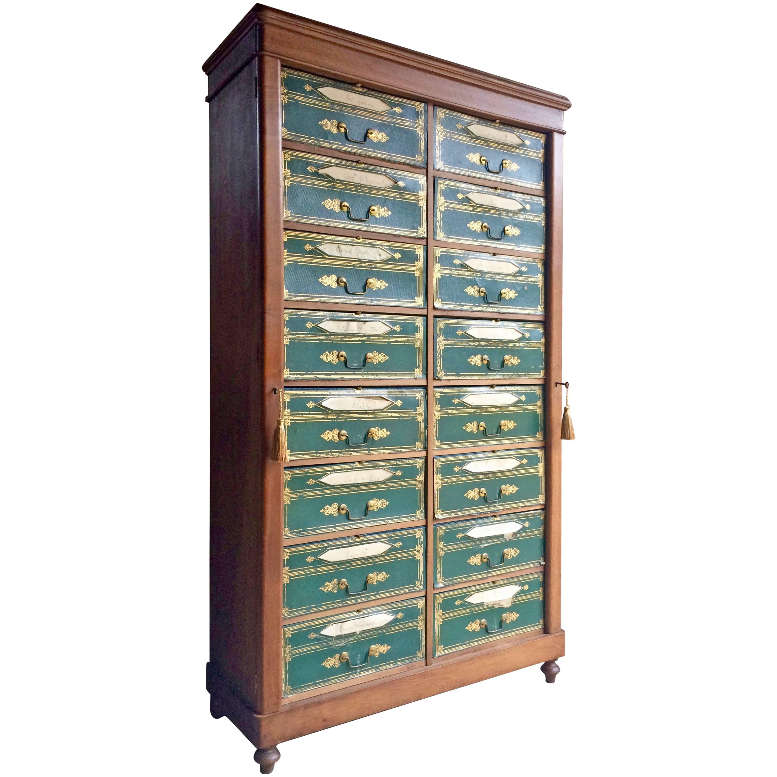 A magnificent Louis Phillipe mahogany and gilt tooled leatherette Cartonnier, circa 1840, of wellington type, incorporating 16 paper lined drawers, fronted by gilt tooled leatherette fronts incorporating title apertures, on a plinth base and turned