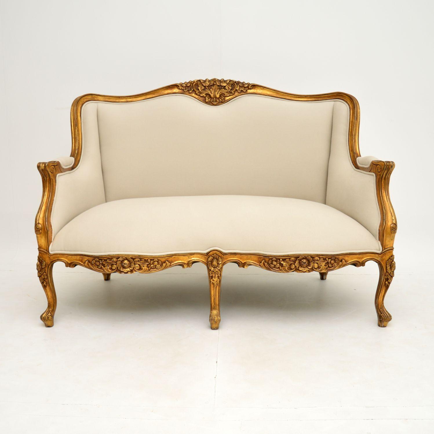 A stunning and top quality two seater sofa in the antique French Louis style & dating from around the 1950’s period.

It is beautifully made, with a gorgeous shape and beautiful carving. The gilt wood frame has some minor wear and distressing to