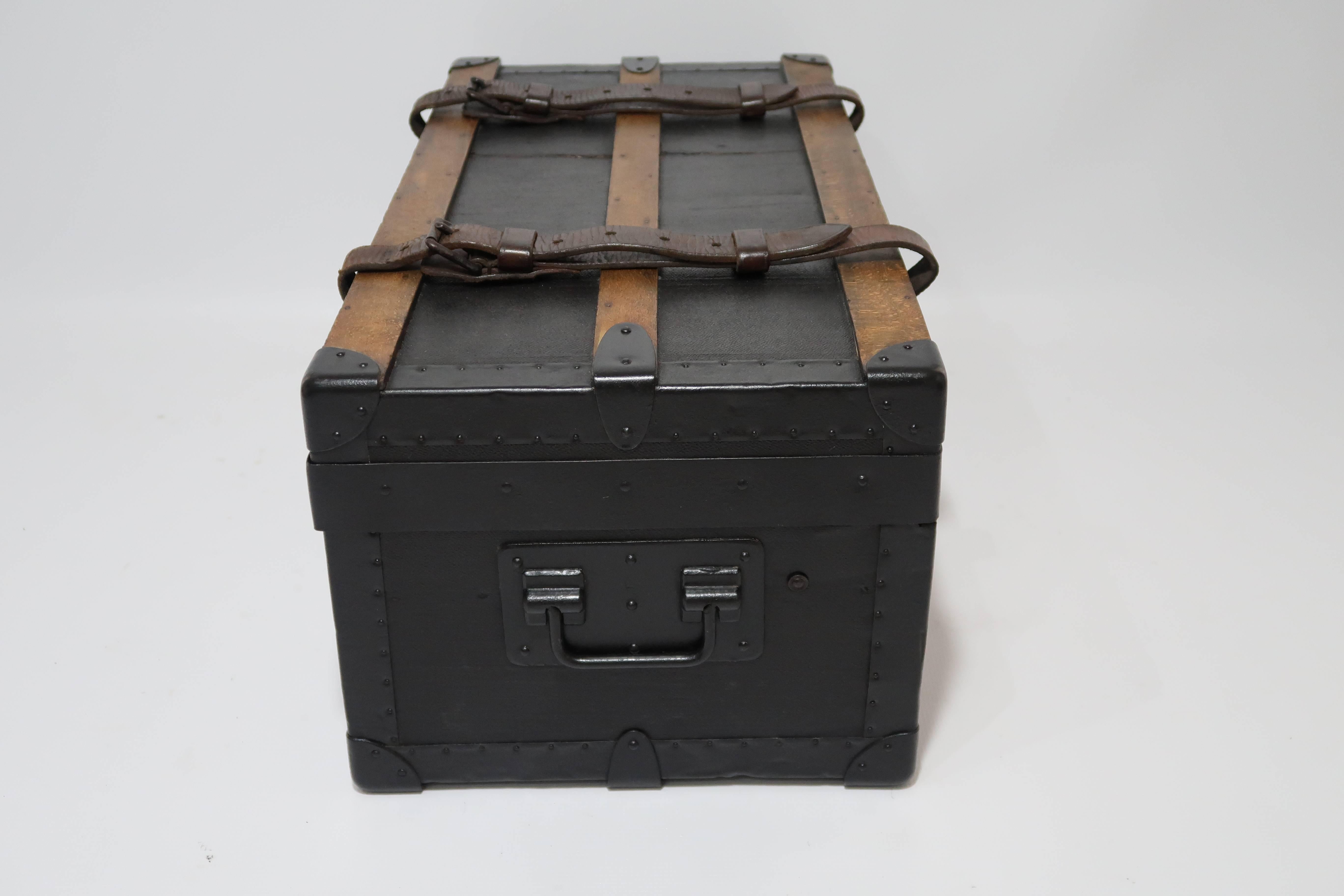 Antique Louis Vuitton army trunk from World War I, belonged to Sous-Lieutenant Caillaux of the French army.

Rare piece of history, in very good condition with a very thick black canvas, wooden slats and leather straps on the top of the