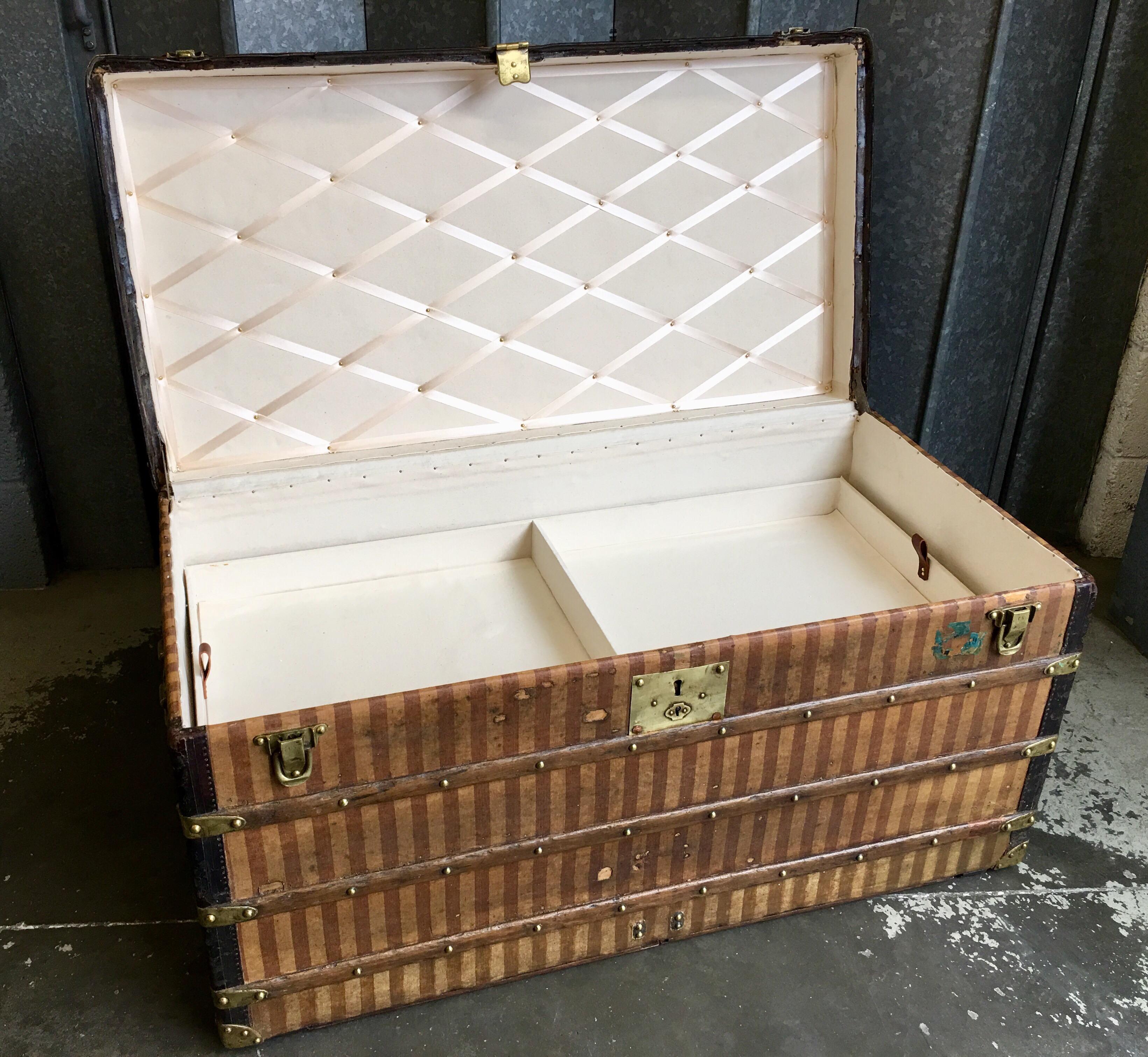 Louis Vuitton trunk in the rayee striped livery. When renovated, the date of manufacture was written in pencil underneath the old lining. The striped rayee fabric was replaced in 1888, so this was one of the last made in the stripe covering.