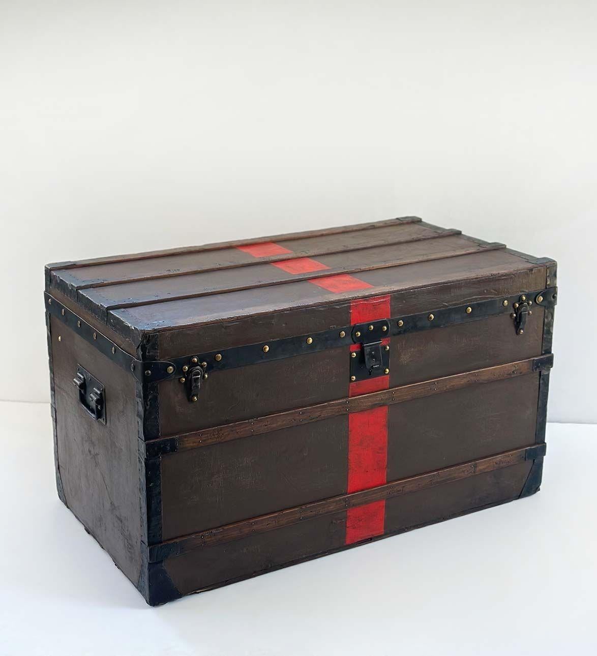 Rare Louis Vuitton steamer trunk with its original interior sticker showcasing its provenance and serial number. Adorned with sleek black  metal trim and hardware which includes 