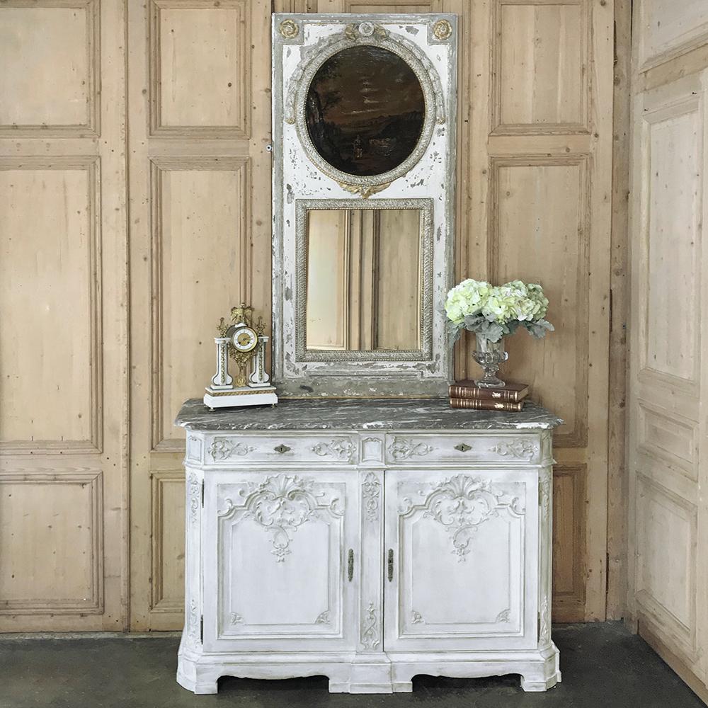 Antique Louis XIV painted marble top buffet was sculpted by master artisans with intricate bas relief in the shell and foliate styles common to the Baroque and Rococo movements, then sturdily constructed around an oaken frame, with rounded corners