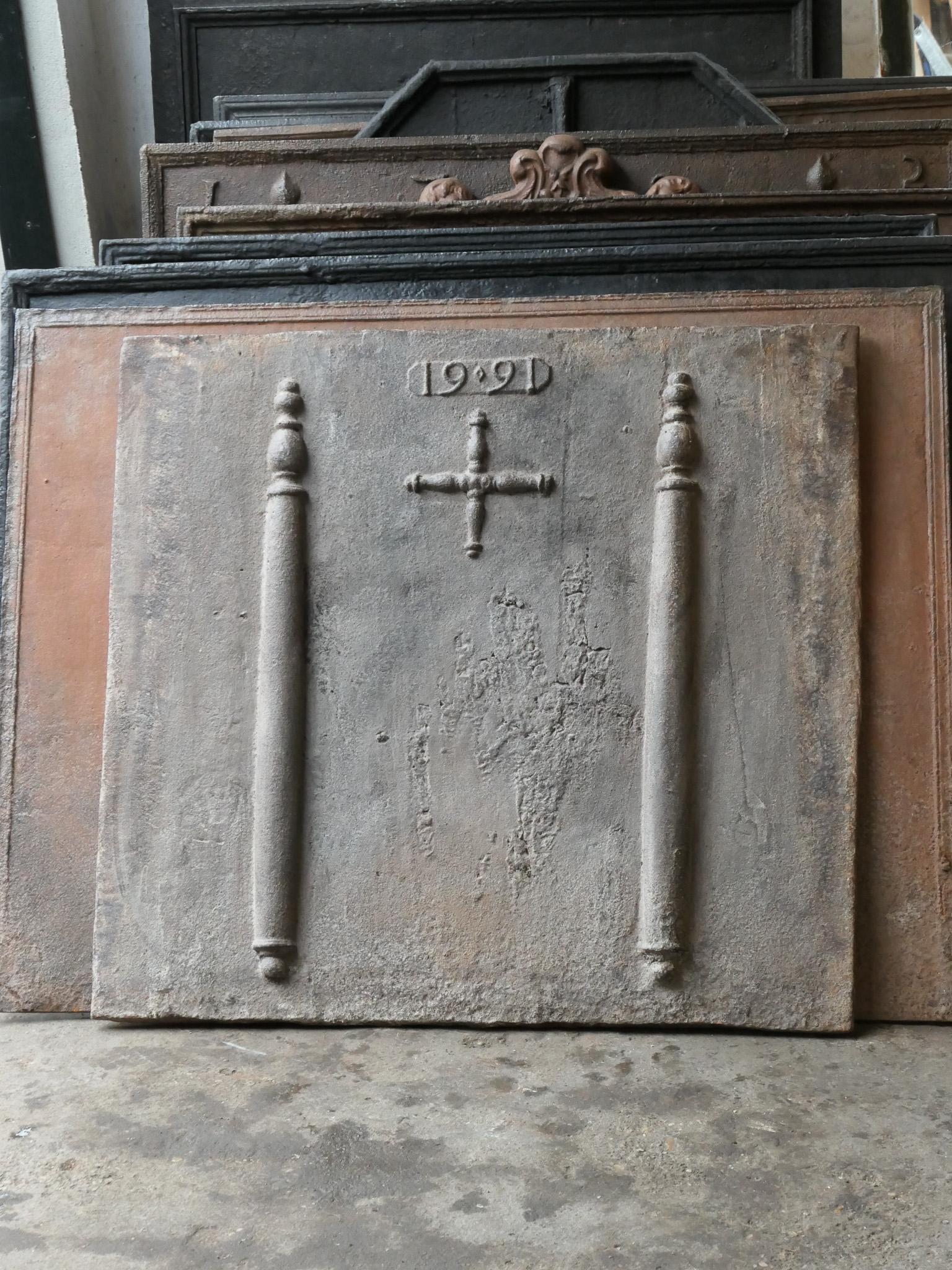 17th century French fireback with a Saint Andrew's cross and two pillars of Hercules. Saint Andrew is said to have been martyred on a cross in this shape. As a result the cross became a sign for humility and sacrifice. The pillars of Hercules