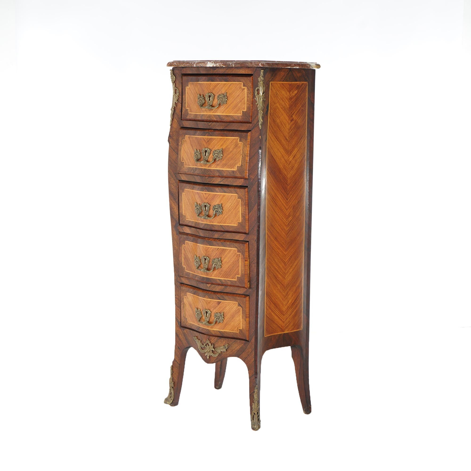 An antique French Louis XIV style lingerie chest offers kingwood and satinwood construction in bombe form and having five drawers, marble top and cast ormolu mounts throughout, 19th century

Measures- 53.5''H x 18.25''W x 13.25''D

Catalogue Note: