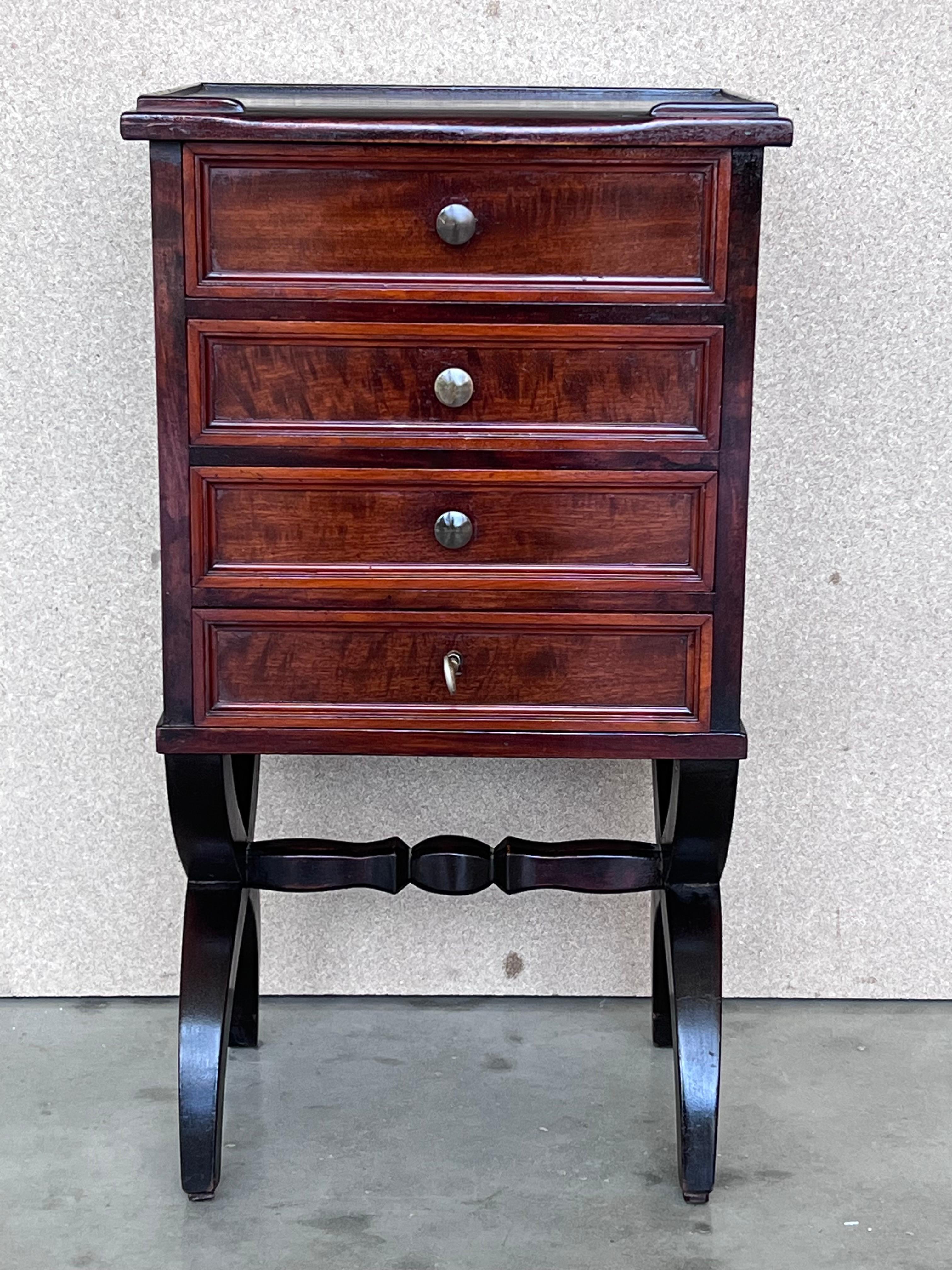 A pair of Antique French Louis XV mahogany nightstands. Subtle contours and scroll shapes are evident in the corner posts and legs, which support serpentine sides and an arched front façade for a curvaceous effect.  The elegantly contoured X shaped