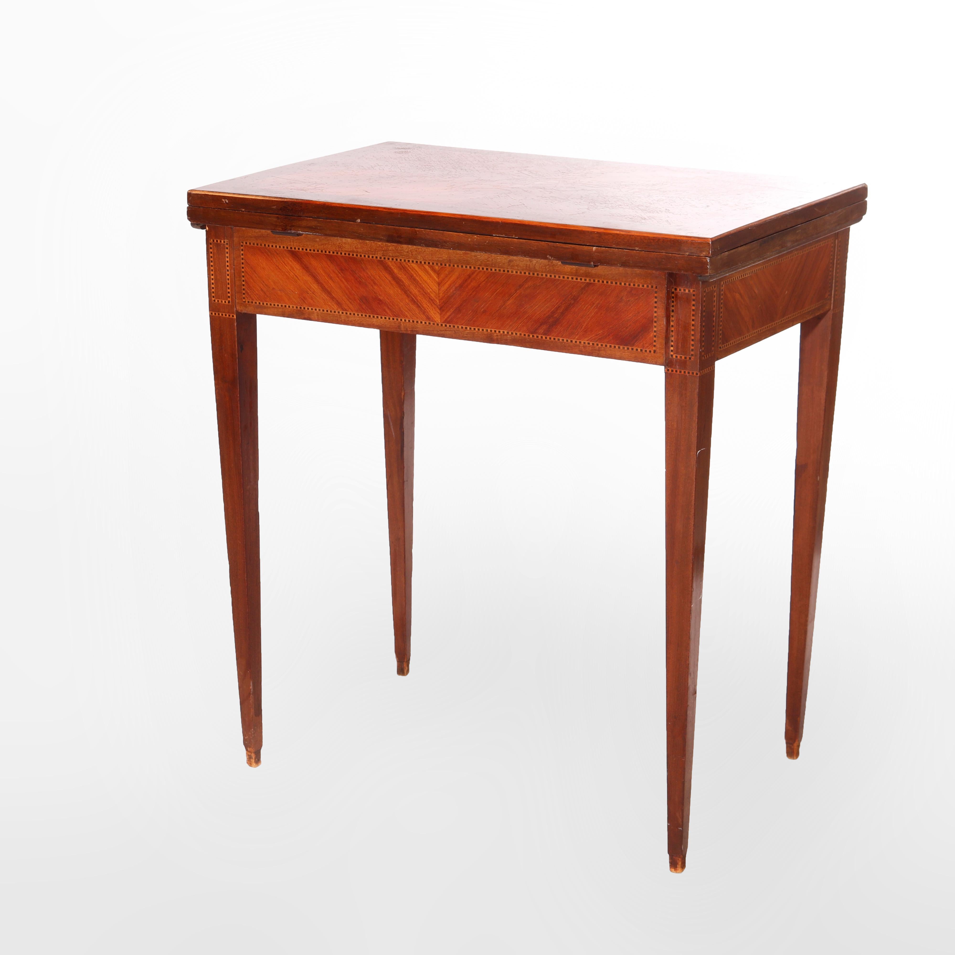 An antique French Louis XV game table offers kingwood and rosewood construction with single drawer and flip-top opening to felt lined gaming surface, bookmatched facing and ebonized inlaid banding throughout, raised on taper legs, 19th