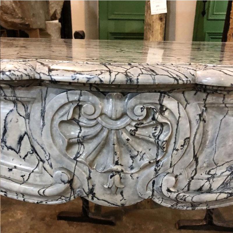 Antique French Louis XV style mantel carved from floral blue marble with a shell in the center of the frieze.

Origin: France,

circa 1830

Measurements:
Approximate 15 1/2