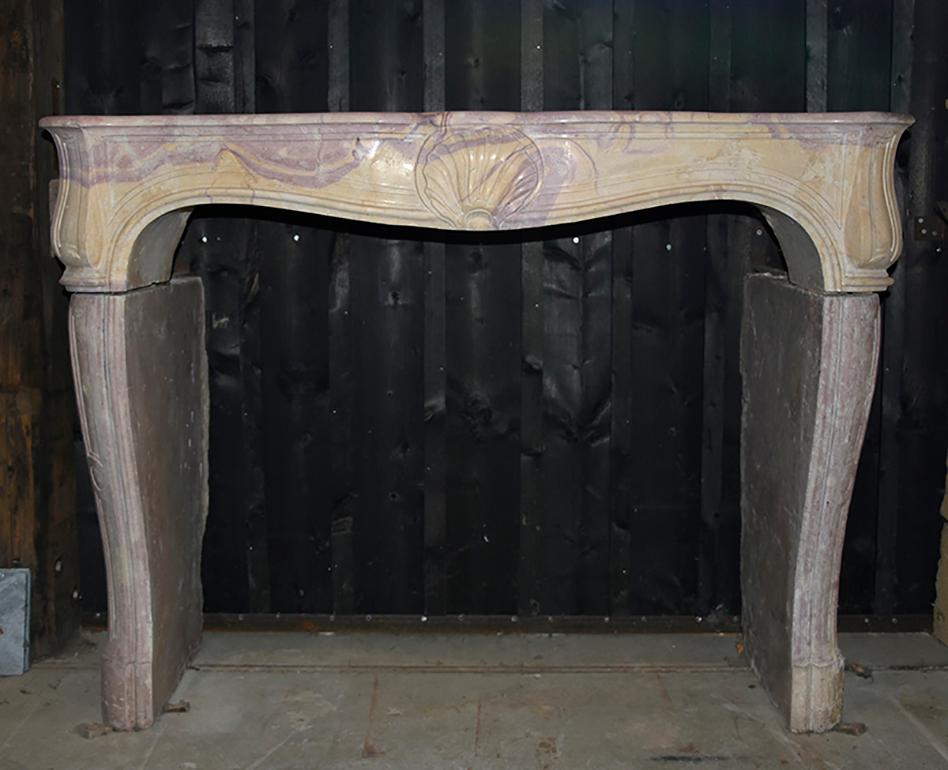 A very beautiful antique marble stone fireplace mantel from
the 19th century in the Louis XV model.
The fireplace needs to be placed in front of the chimney and
is recuperated from France.