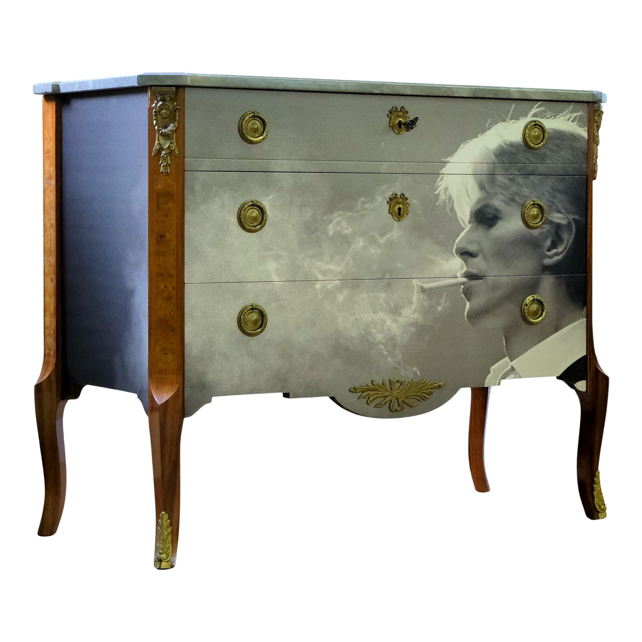 Antique Gustavian Bureau in birch wood dating from the 1920's/1930 with a lacquered photo print David Bowie over the front drawers and side.

Fine grey marbled slab and solid original brass fittings. 
Measures: Width: 108cm / 42.5