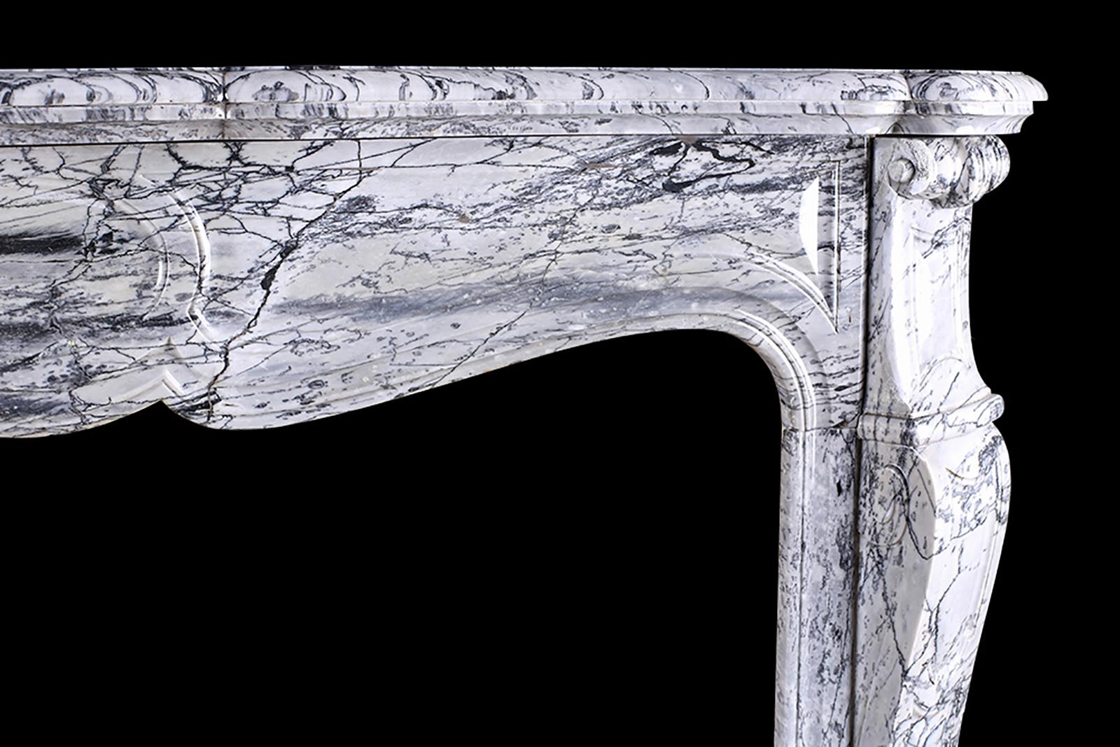 Antique Louis XV Pompadour fireplace mantel, Circa 1870

A Louis XV Pompadour antique fireplace mantel very finely carved in Italian grey veined white Carrara marble, with a serpentine shelf over the finely carved panelled frieze and decoratively