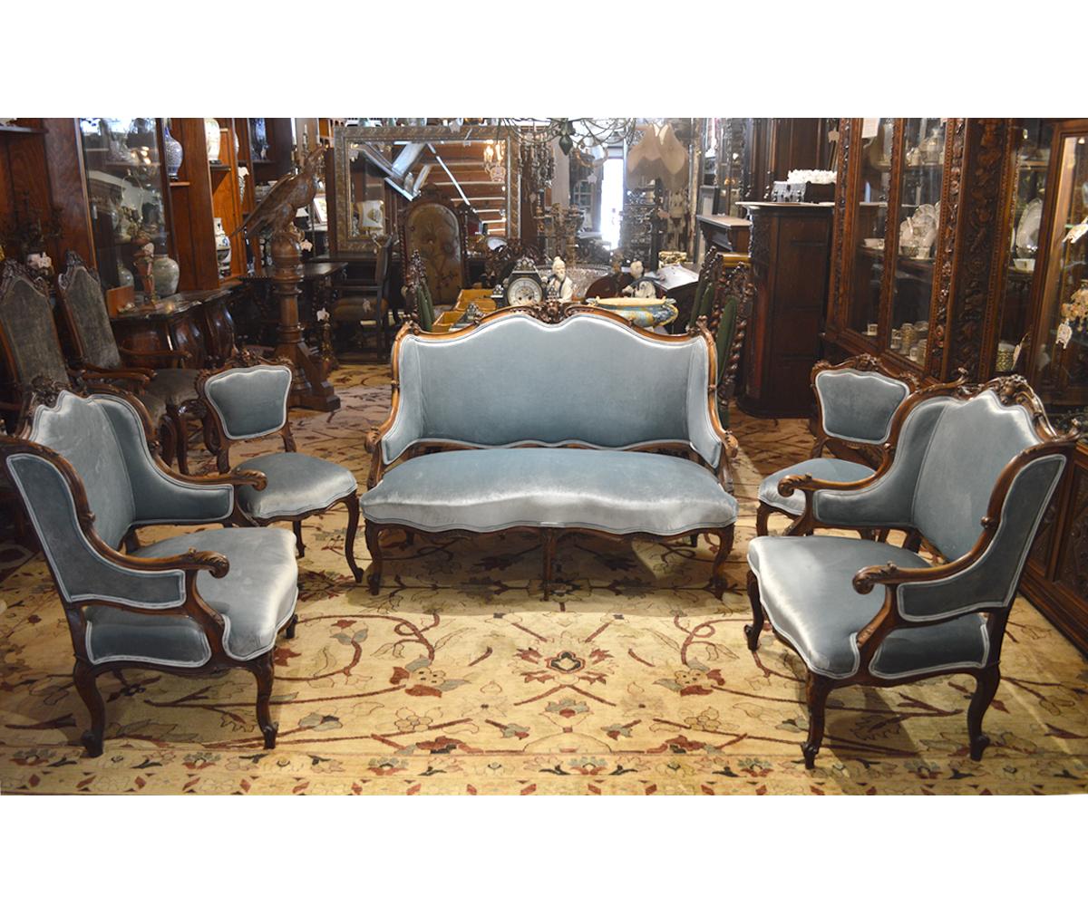 This lovely set has been completely restored and reupholstered in-house with a gorgeous light sea foam blue velvet fabric. The five piece set includes two armchairs, two side chairs and a settee each with the excellent carving for which the French