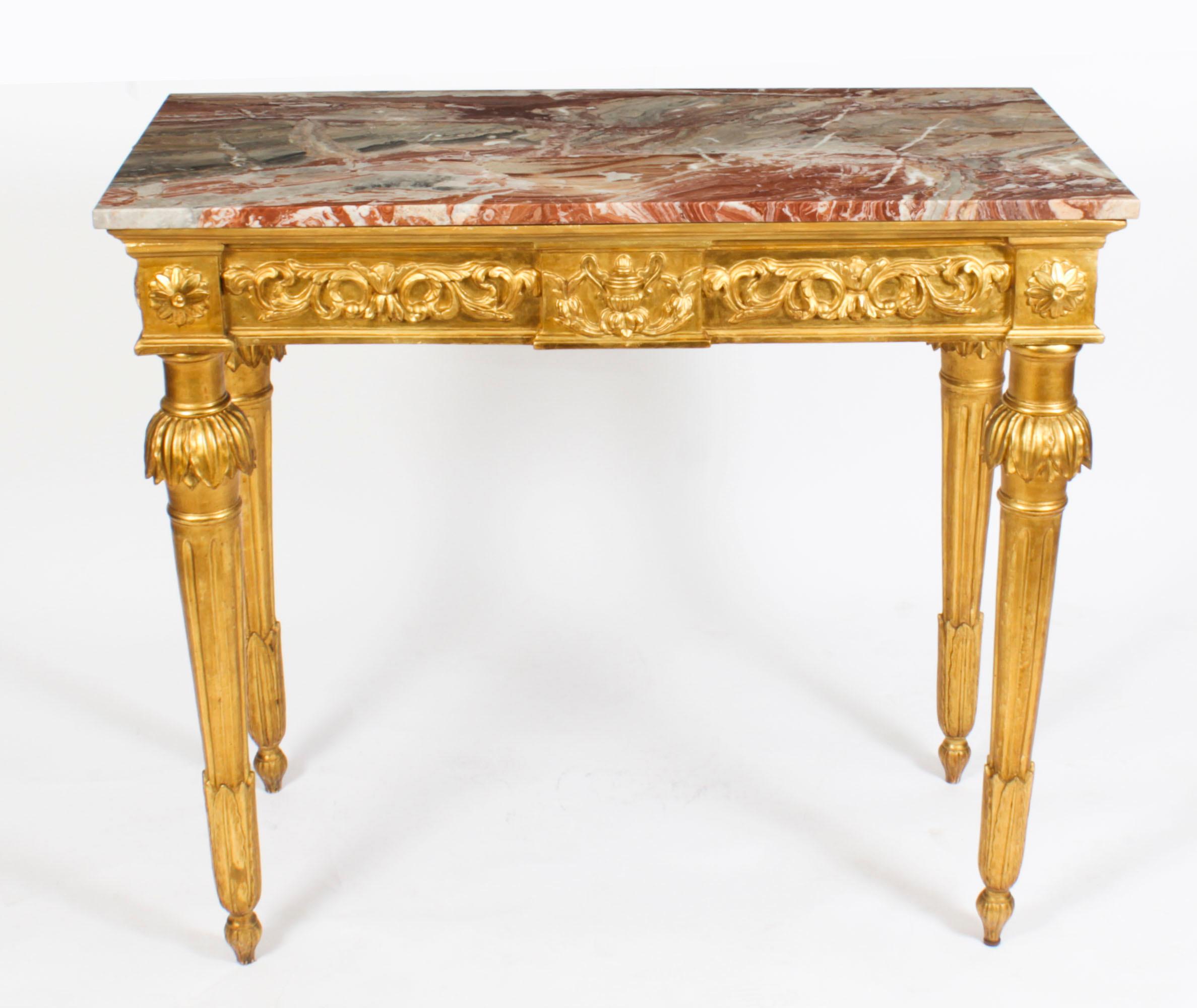A fine antique Louis XV Revival carved giltwood marble topped console table, circa 1870 in date.
 
This finely carved giltwood console table is surmounted with an exquisite shaped rectangular Italian Breccia marble top above a frieze carved with