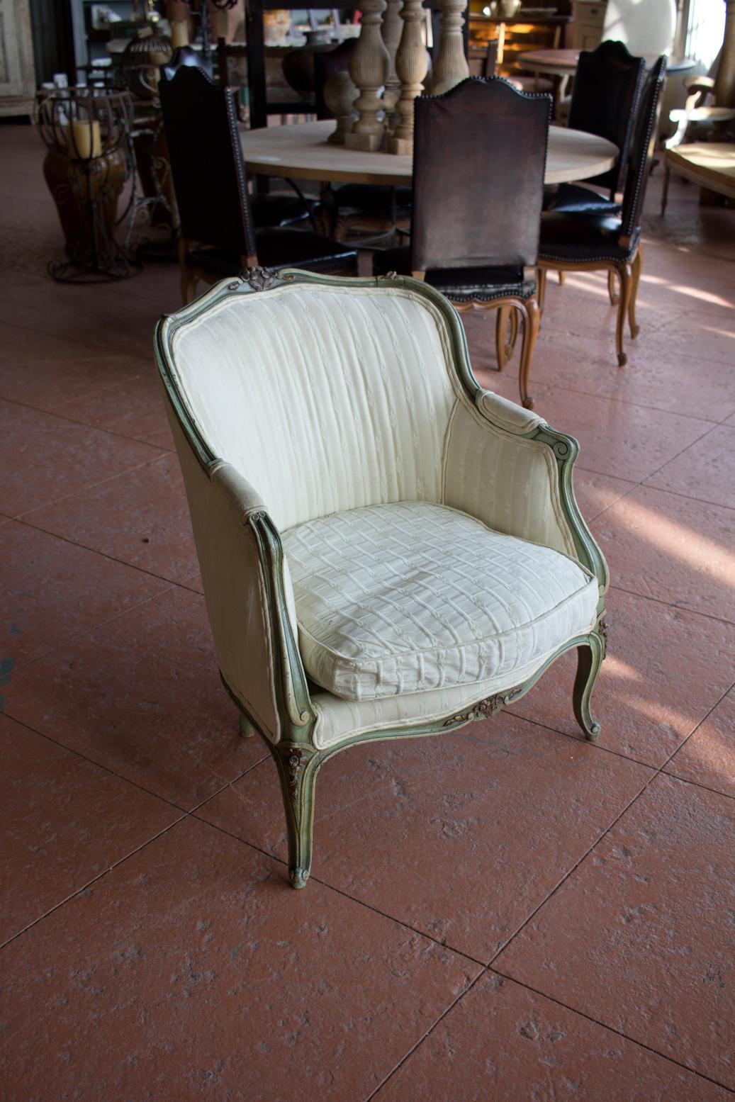 Antique Louis XV style bergère chair with beautiful carving and old paint.