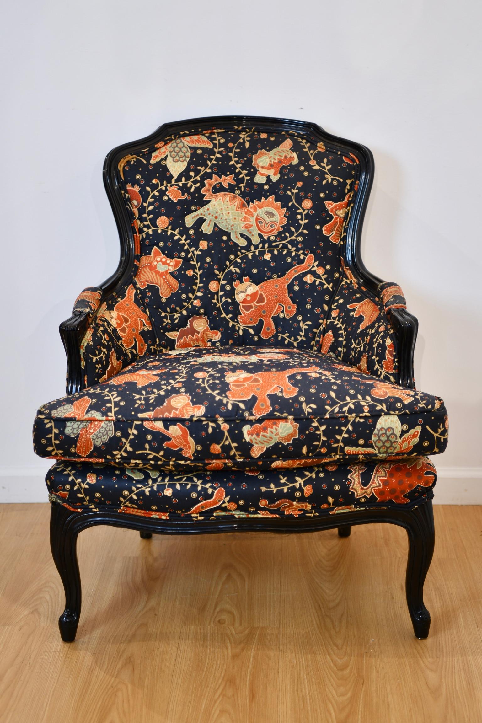 Antique Louis XV style bergere with Chinoiserie upholstery. Frame painted in dark blue lacquer. Two available, sold individually. Dimensions: 35