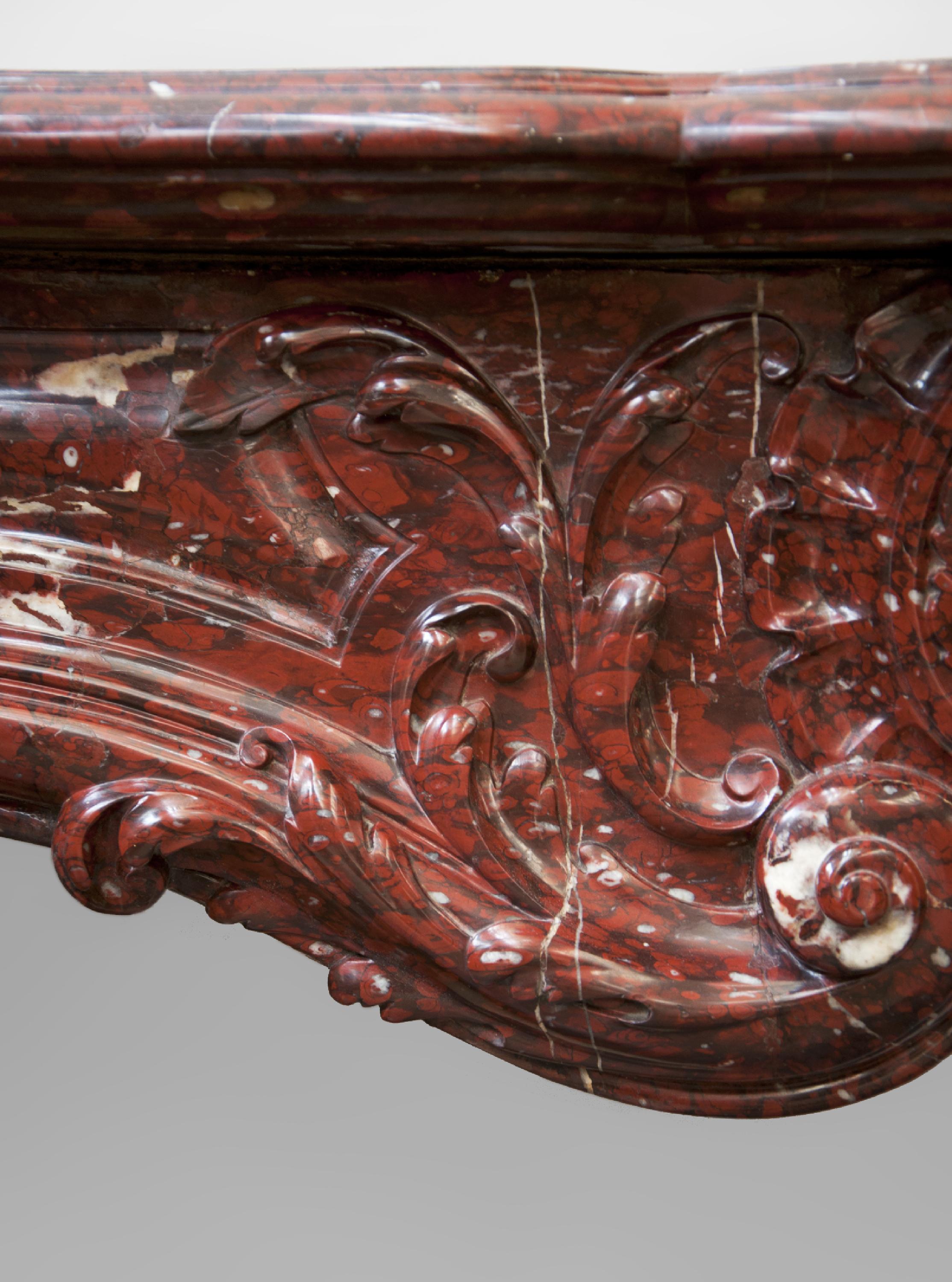 Carved Antique Louis XV Style Fireplace Sculpted Out of Red Griotte  For Sale