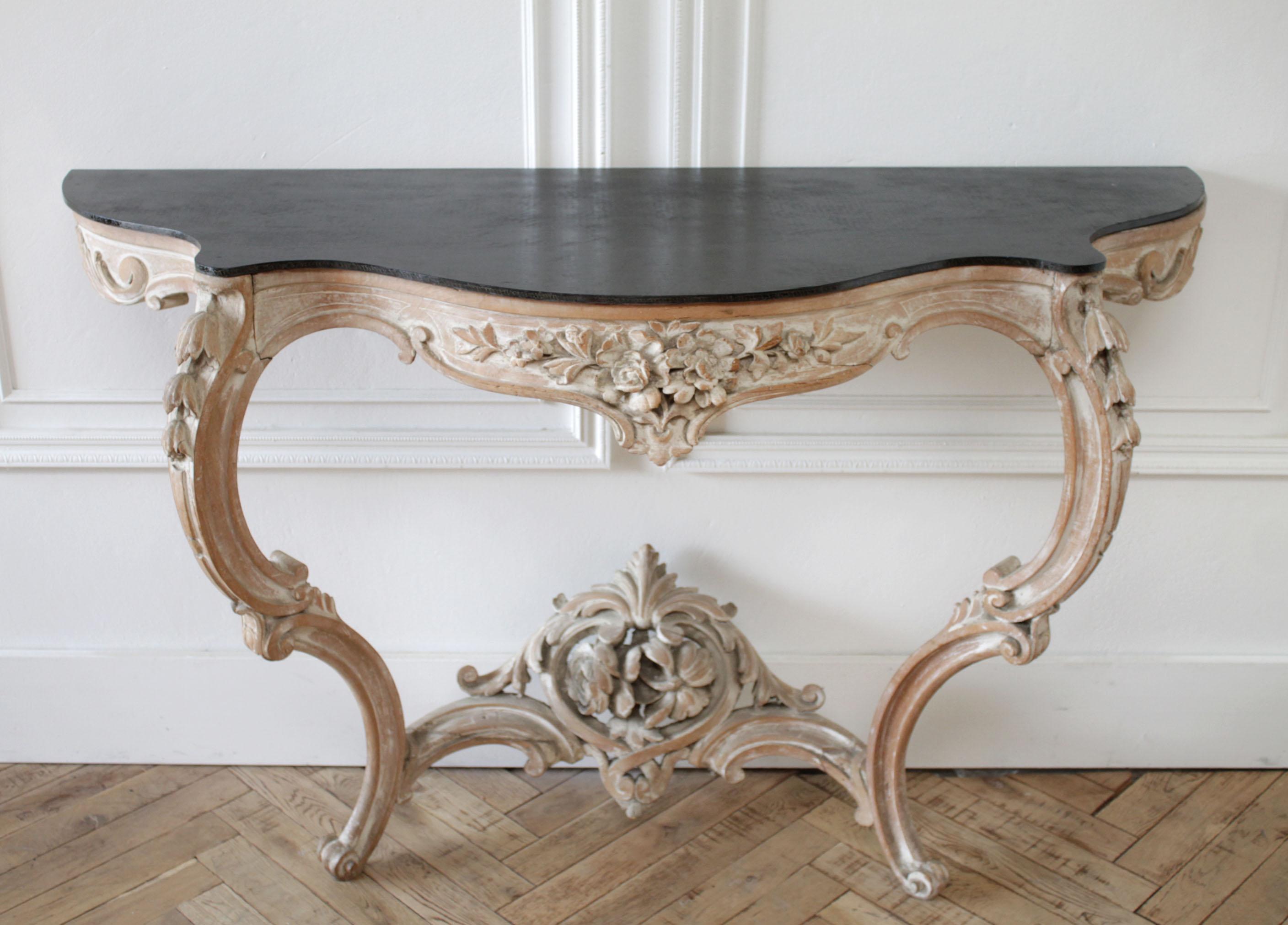 Antique Louis XV style French carved console wall table
circa 19th-early 20th century, stripped down to the natural wood with a white wash pickled effect.
The top is removable, but is wood in a painted black finish.
Stone can be added.
Must be