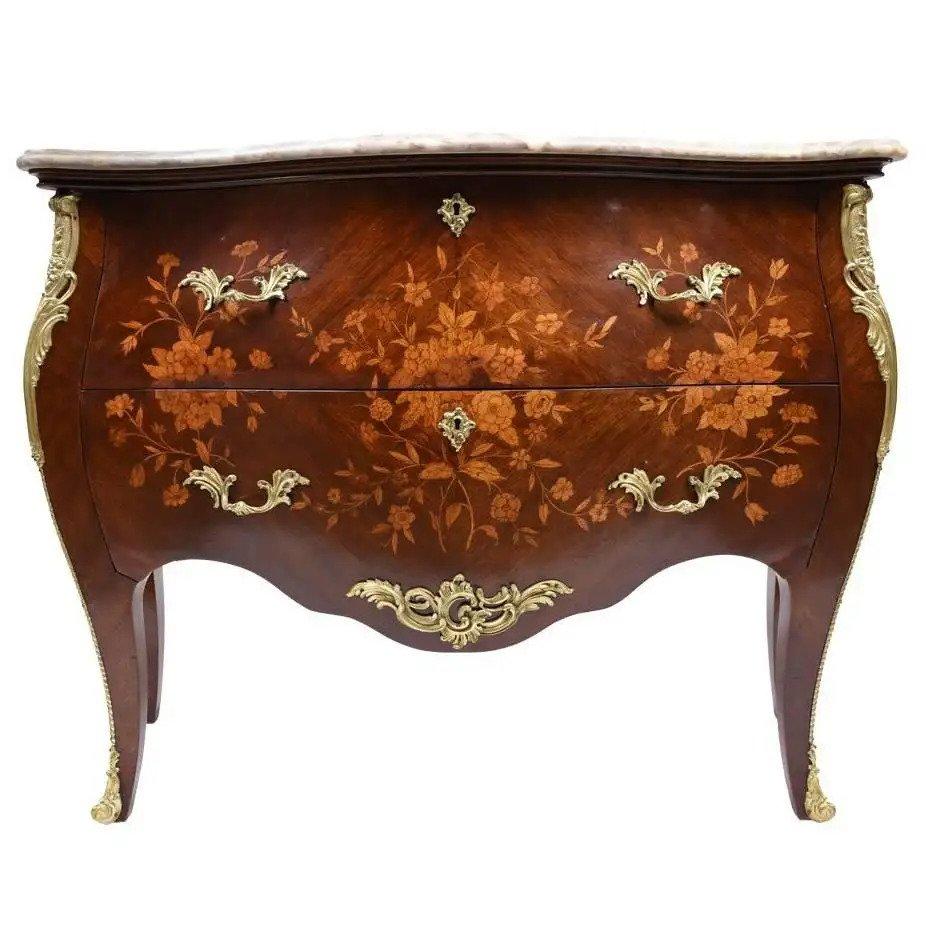 Immerse yourself in the elegance of the past with our stunning antique Louis XV-style commode, a piece that reflects the exquisite craftsmanship of its time. Expertly constructed from solid wood and enhanced with fruitwood veneers, our professional