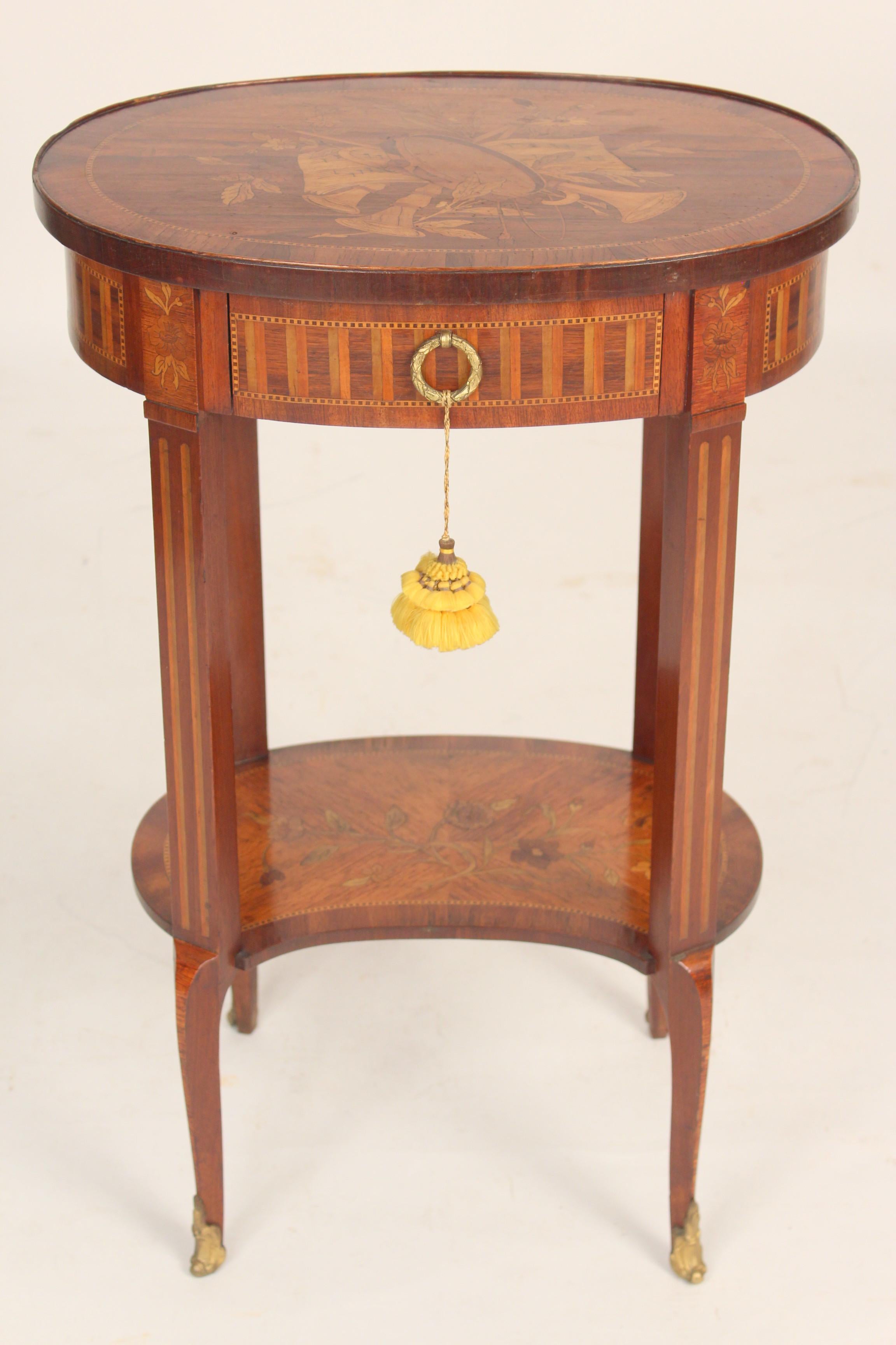 Antique Louis XV style inlaid occasional table with musical trophy inlaid top, circa 1900. Exquisitely inlaid and hand dove tailed drawer construction.