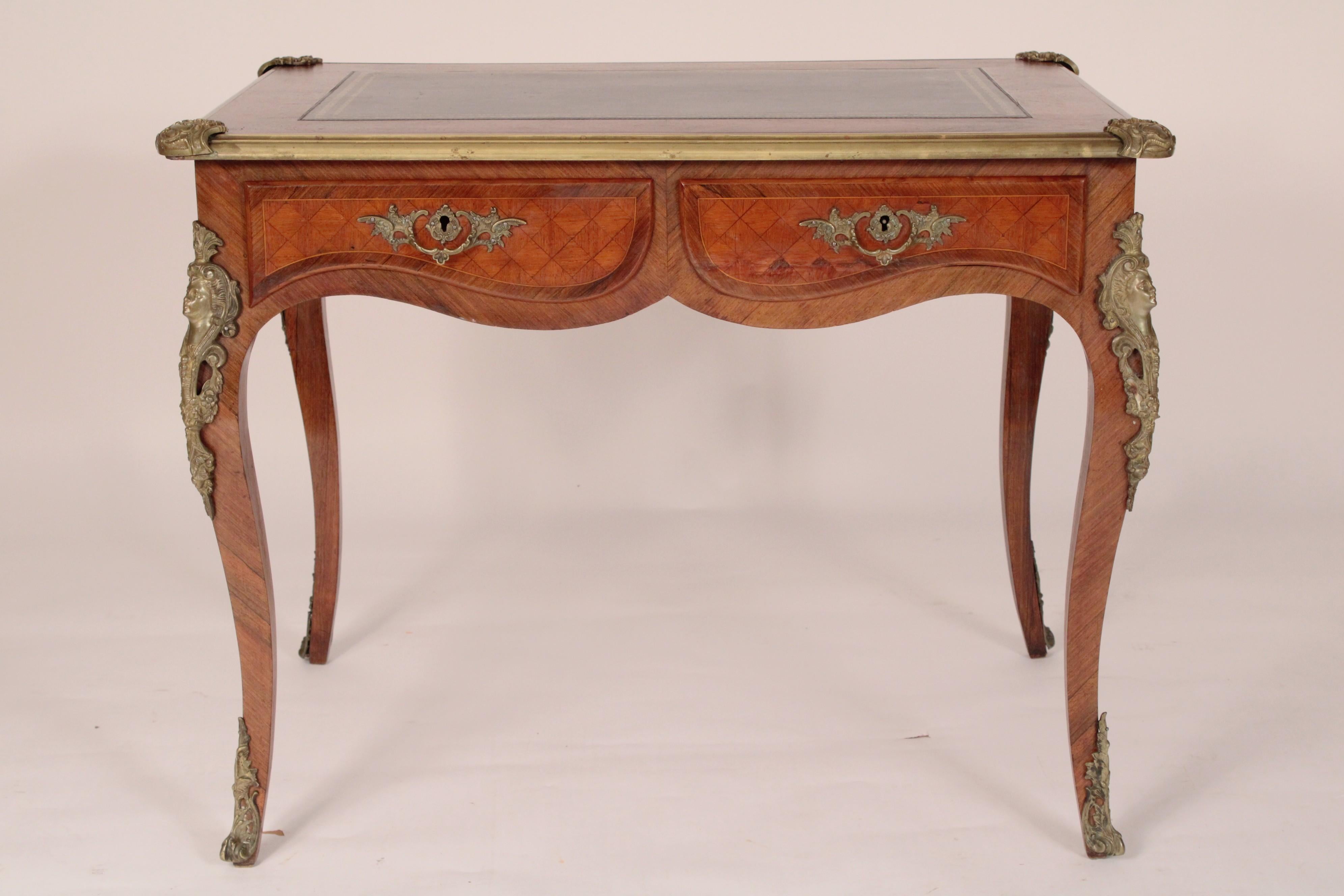 Antique Louis XV style kingwood and tulipwood leather top desk with bronze mounts, circa 1920. The top with an inset tooled leather top with king wood outer banding, two drawers each with tulip wood parquetry inlay and bronze hardware, a double