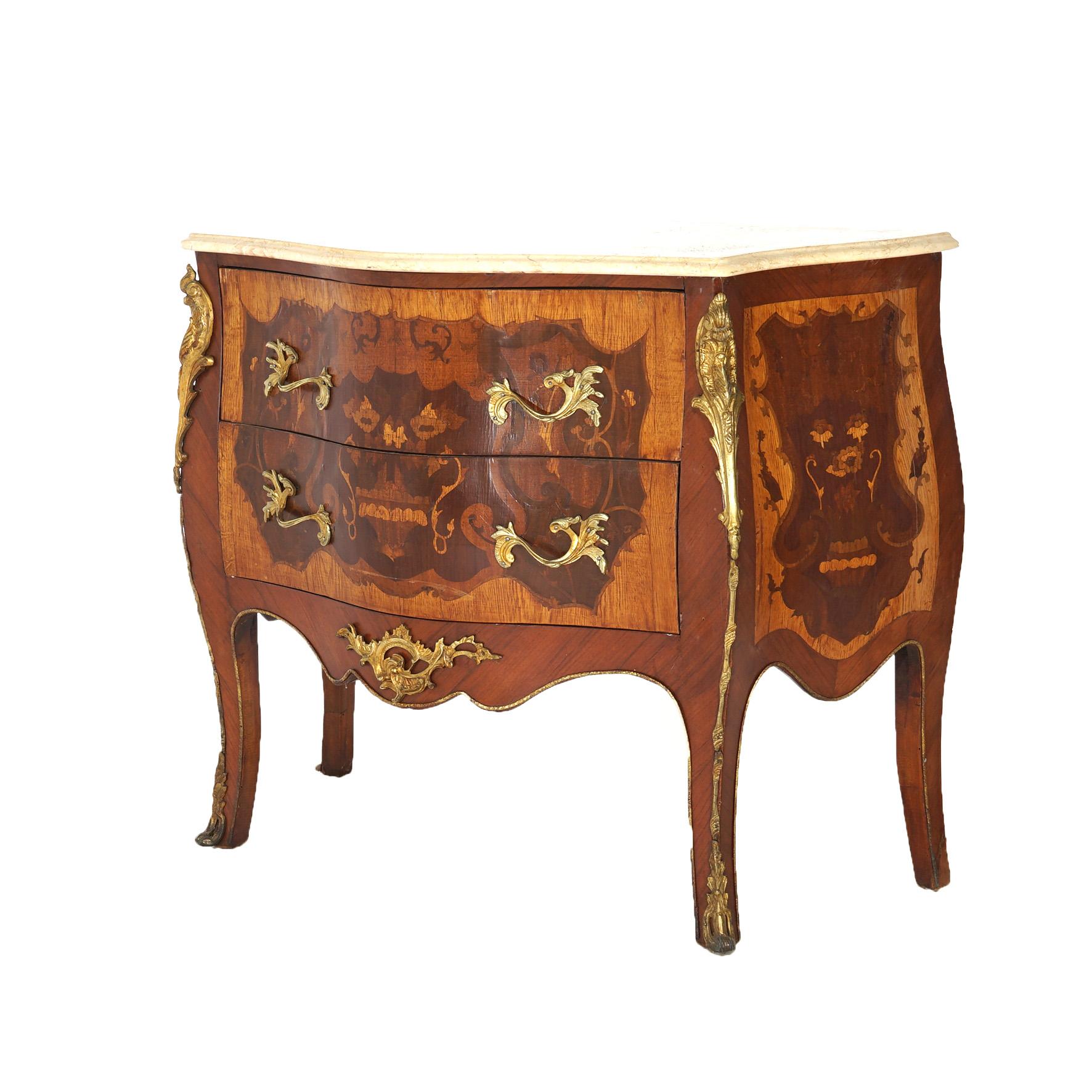 An antique French Louis XIV style commode offers shaped and beveled marble top over satinwood and kingwood case having two drawers, foliate and floral marquetry inlay, ormolu mounts and raised on cabriole legs, 20th century

Measures - 32