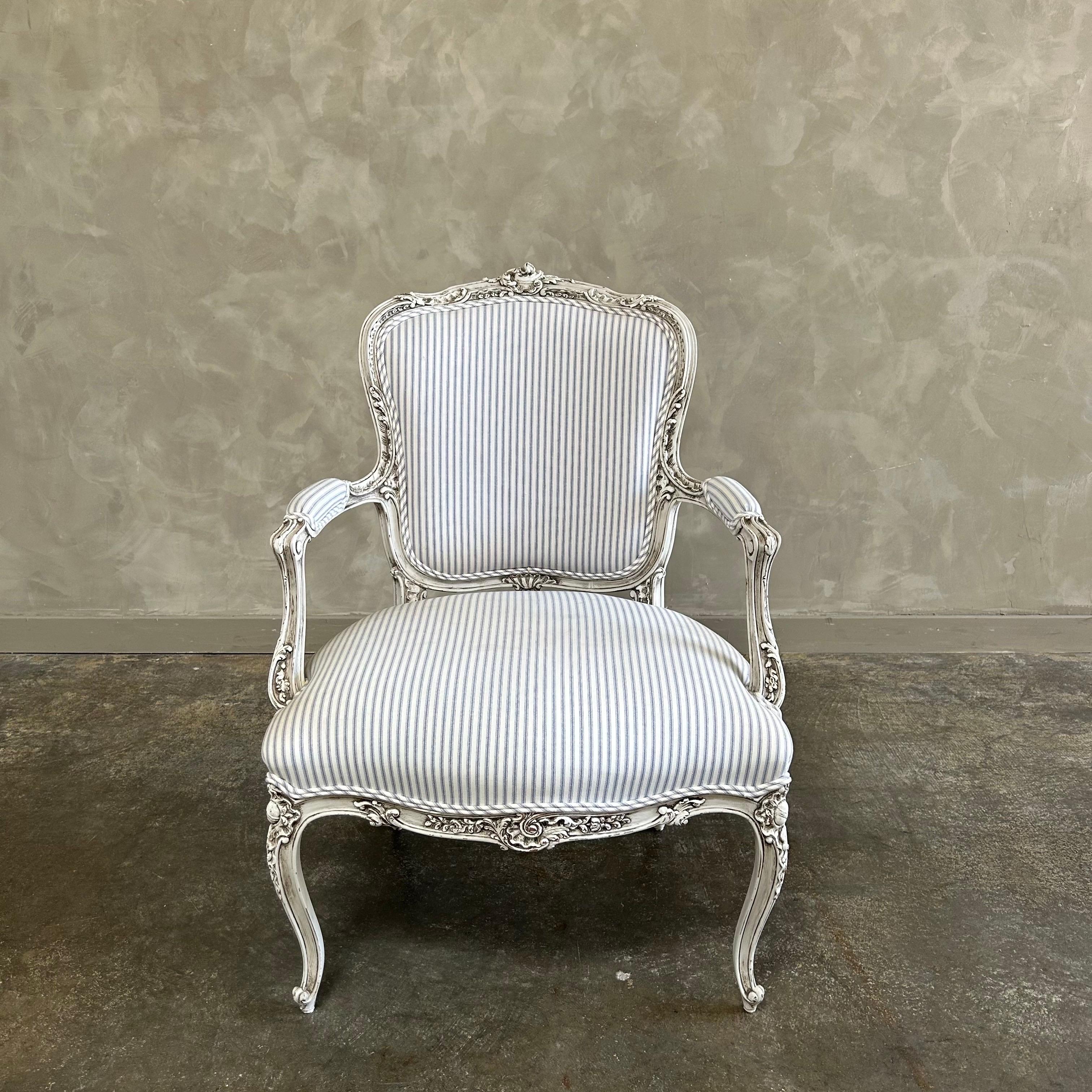 Antique French Louis XV Style chair. painted in a french oyster white finish with subtle distress edges, finished with an antique patina. Upholstered seat and back in a versatile stripe fabric, solid and sturdy ready for everyday use. 
Dimensions: