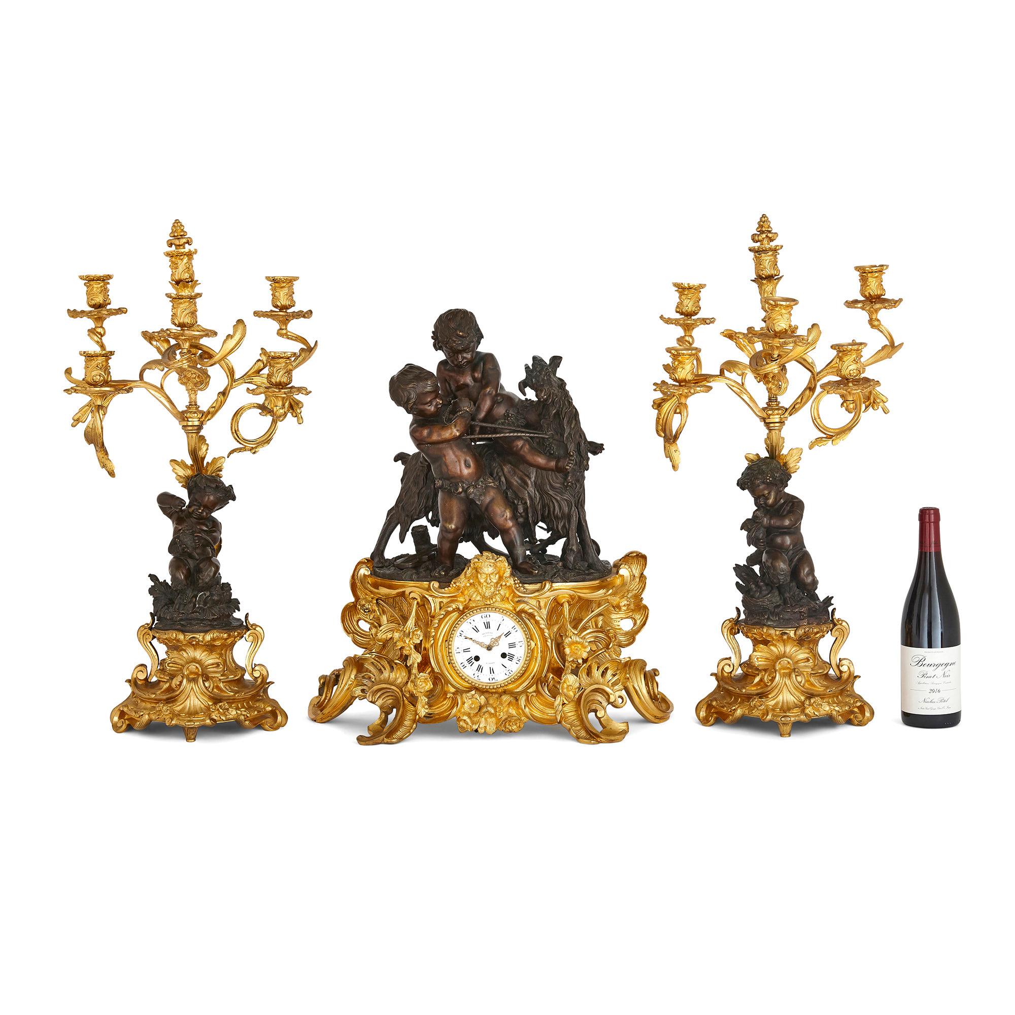 Antique Rococo Louis XV style ormolu and patinated bronze clock set by Denière et Fils
French, c. 1870
Clock: Height 59cm, width 52cm, depth 23cm
Candelabra: Height 71cm, width 33cm, depth 28cm

Designed in the ornate Louis XV Rococo style,