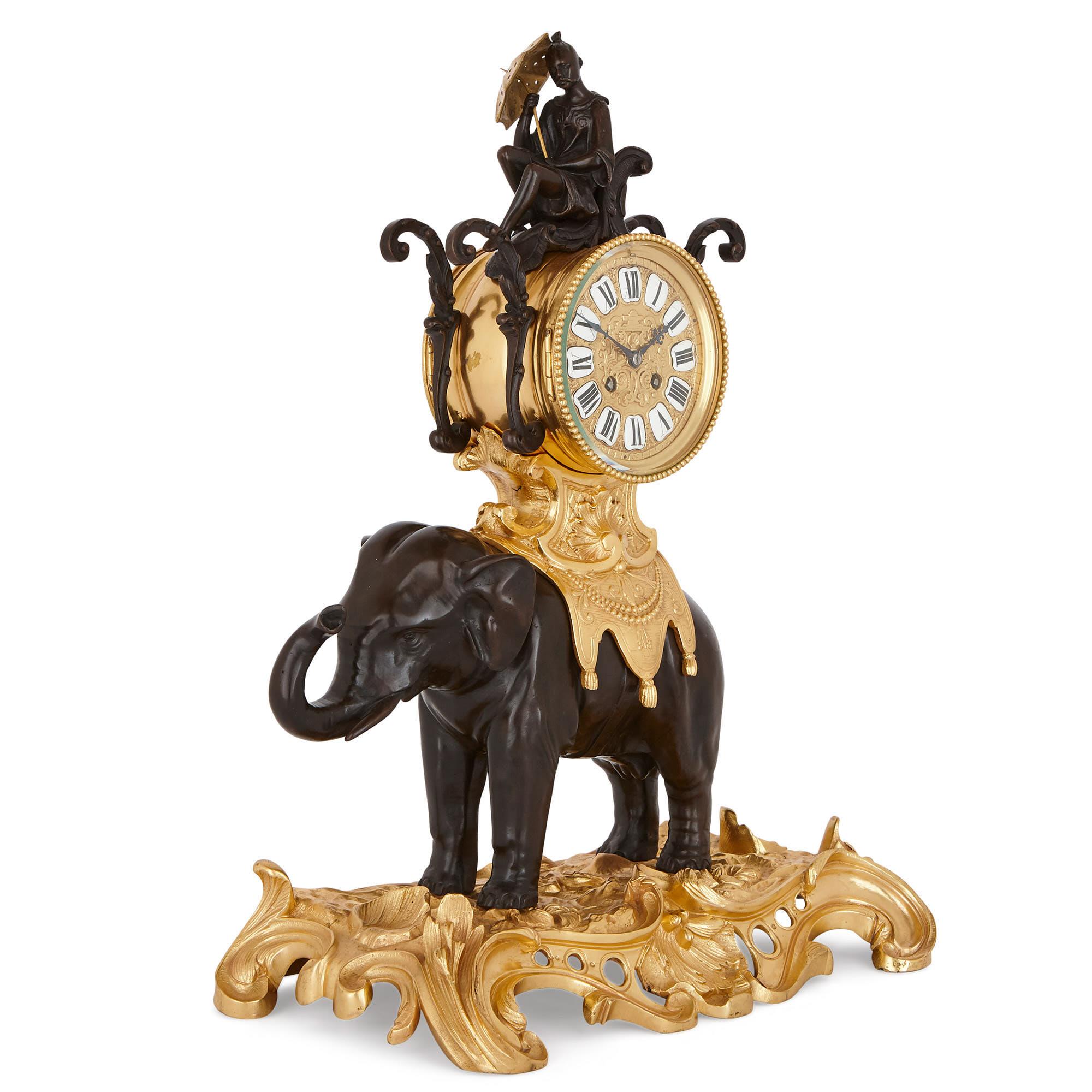 Designed in a fanciful Louis XV style, this beautiful mantel clock takes the form of an Asian elephant, saddled with a howdah (carriage). The clock features a patinated sculpture of a Chinese man, seated on a chair atop a gilt bronze clock dial. The